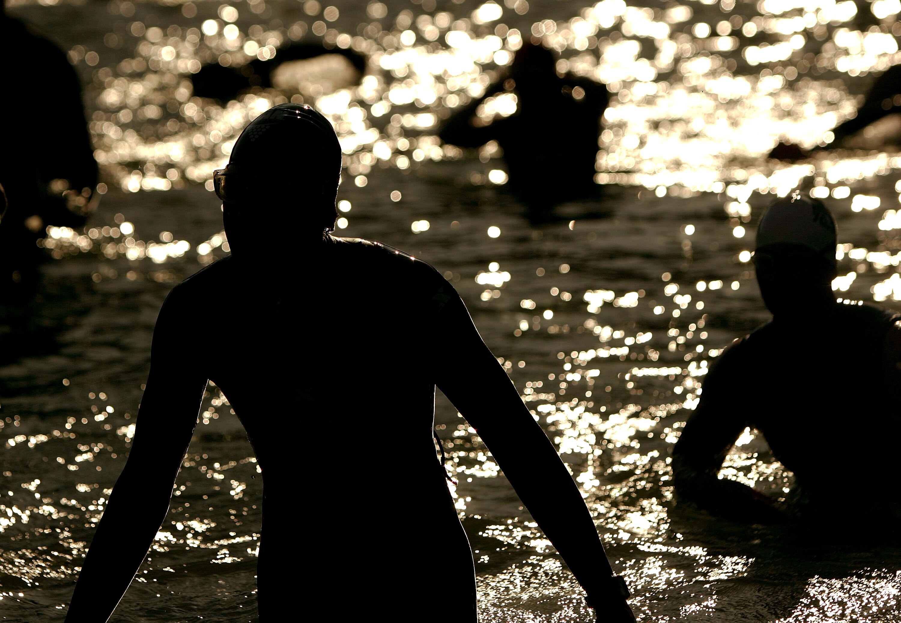 SANTA ROSA, CA - JULY 19: Athletes exit the water after finishing the 1.2 mile swim in the Vineman Ironman 70.3 on July 19, 2009 in Santa Rosa, California. The Vineman Ironman 70.3 Triathlon, which is held in Sonoma County, California (about one hour nort