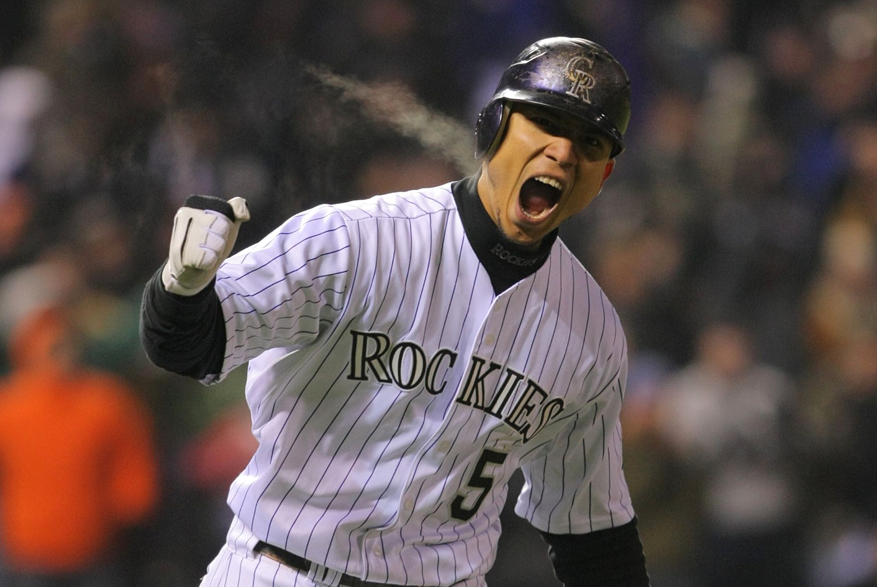 DENVER - OCTOBER 11:  Carlos Gonzalez #5 of the Colorado Rockies reacts after hitting a home run in the bottom of the fourth inning against the Philadelphia Phillies in Game Three of the NLDS during the 2009 MLB Playoffs at Coors Field on October 11, 2009