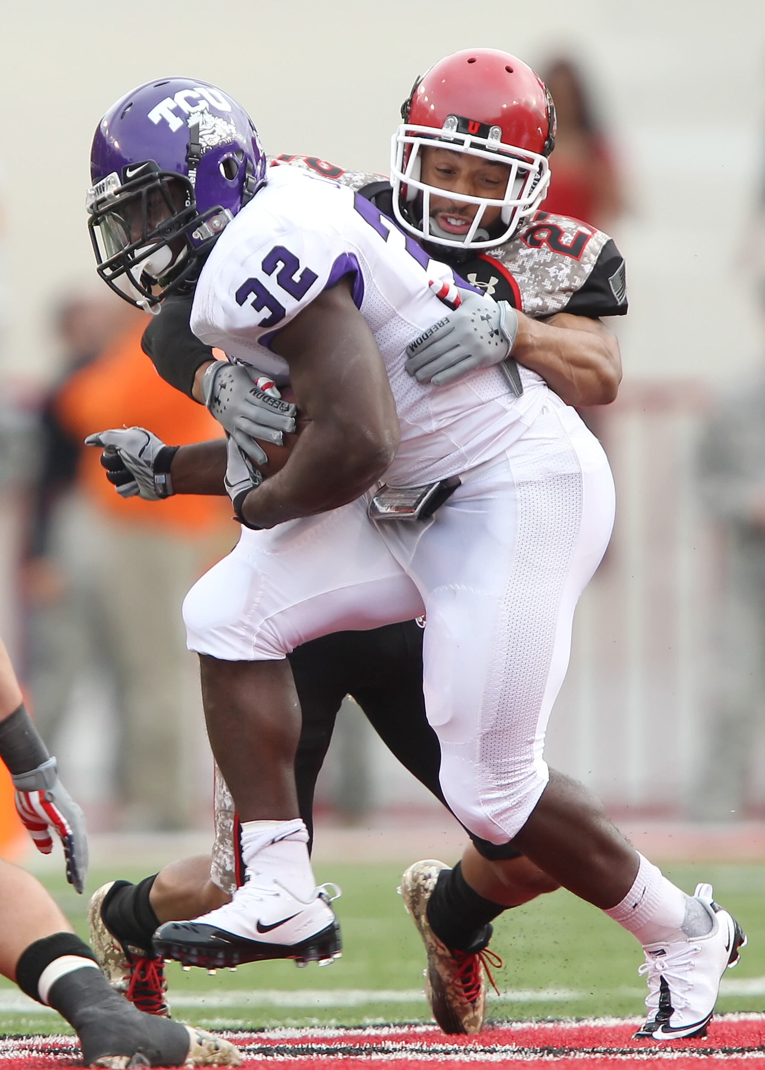 SALT LAKE CITY, UT - NOVEMBER 6: Waymon James #32 of the TCU Horned Frogs is hit by Brandon Burton #27 the Utah Utes during the second half of an NCAA Football game November 6, 2010 at Rice-Eccles Stadium in Salt Lake City, Utah. TCU Beat Utah 47-7. (Pho SALT LAKE CITY, UT - NOVEMBER 6: Waymon James #32 of the TCU Horned Frogs is hit by Brandon Burton #27 the Utah Utes during the second half of an NCAA Football game November 6, 2010 at Rice-Eccles Stadium in Salt Lake City, Utah. TCU Beat Utah 47-7. (Pho