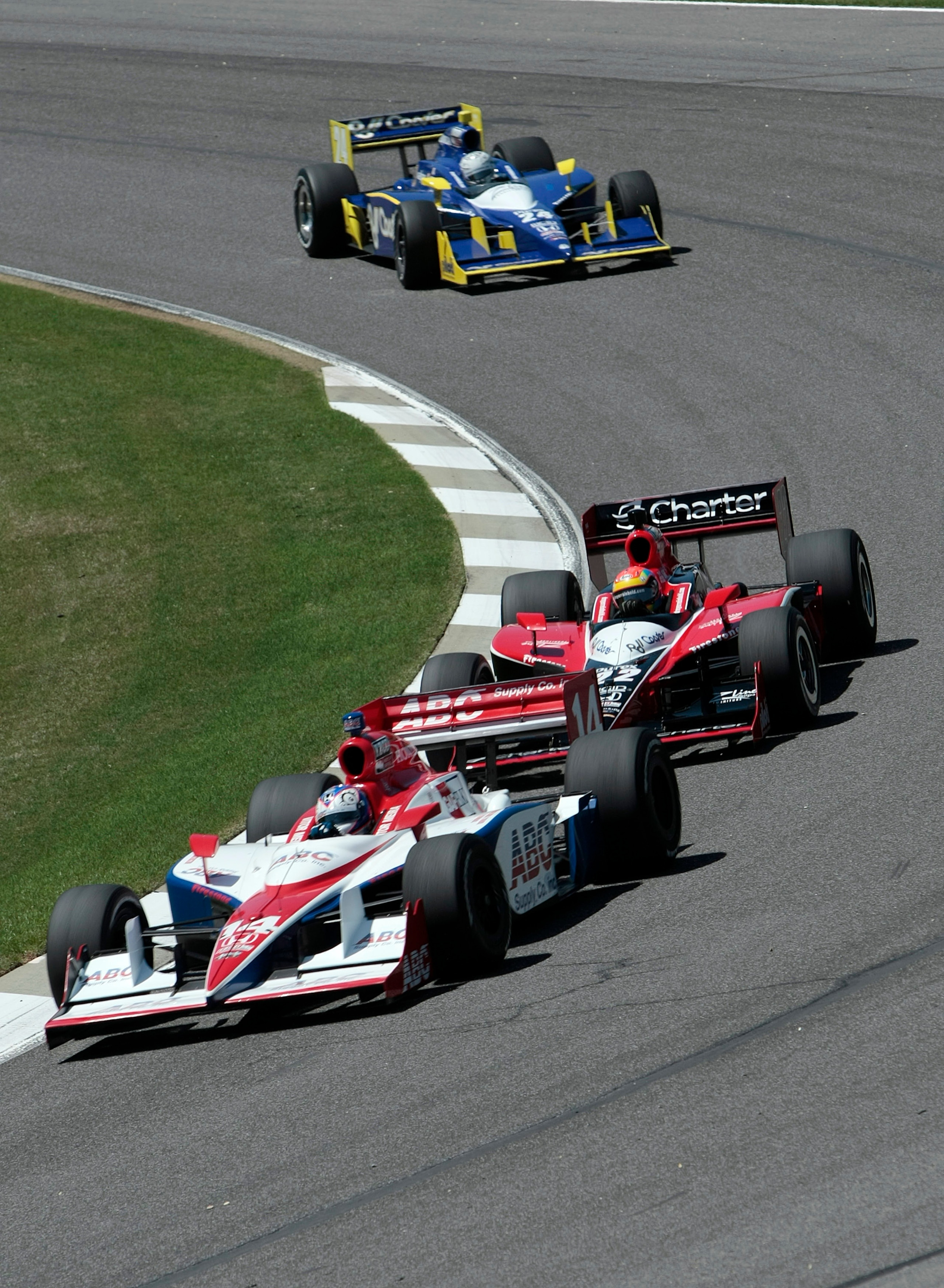 LEEDS, AL - APRIL 09:   Vitor Meira #14 of Brazil leads Justin Wilson #22 of England and Mike Conway #24 of England thru turn two during practice for the IRL IndyCar Series Grand Prix of Alabama at the Barber Motorsports Park on April 9, 2010 in Leeds, Al