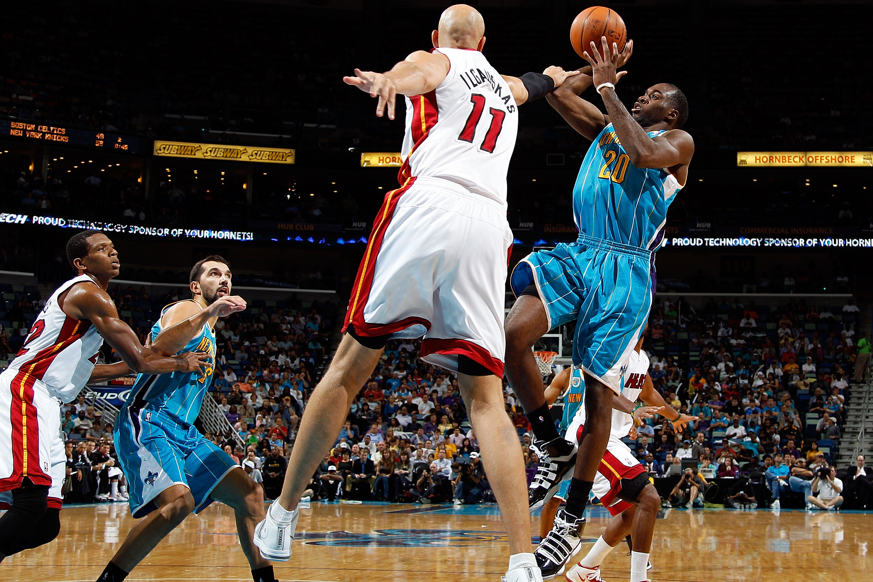 NEW ORLEANS - OCTOBER 13:  Zydrunas Ilgauskas #11 of the Miami Heat tries to block the shot of Quincy Pondexter #20 of the New Orleans Hornets at the New Orleans Arena on October 13, 2010 in New Orleans, Louisiana.  NOTE TO USER: User expressly acknowledg