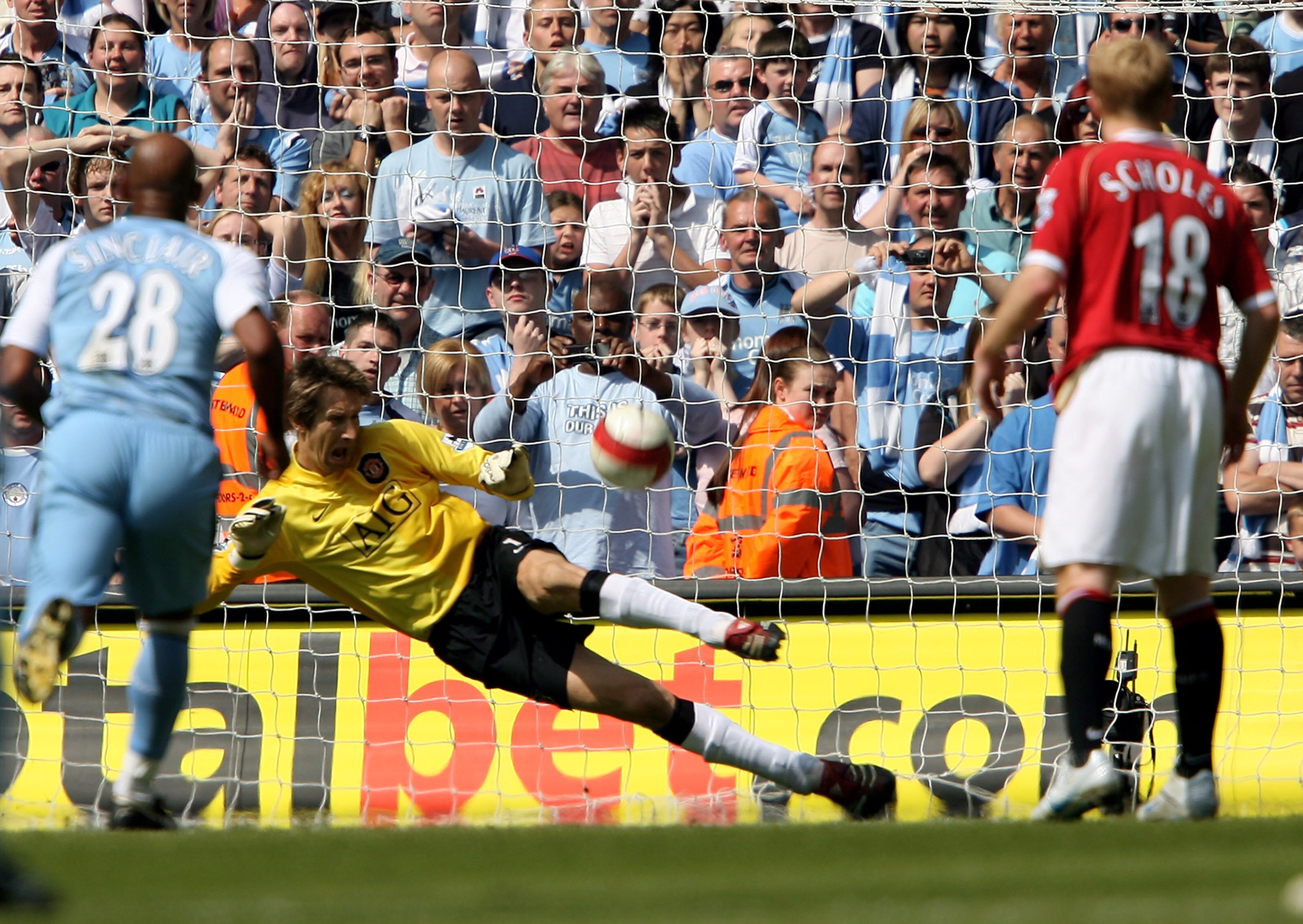 MANCHESTER, UNITED KINGDOM - MAY 05:  Goalkeeper Edwin van der Sar (C) of Manchester United saves the penalty from Darius Vassell of Manchester City during the Barclays Premiership match between Manchester City and Manchester United at the City of Manches
