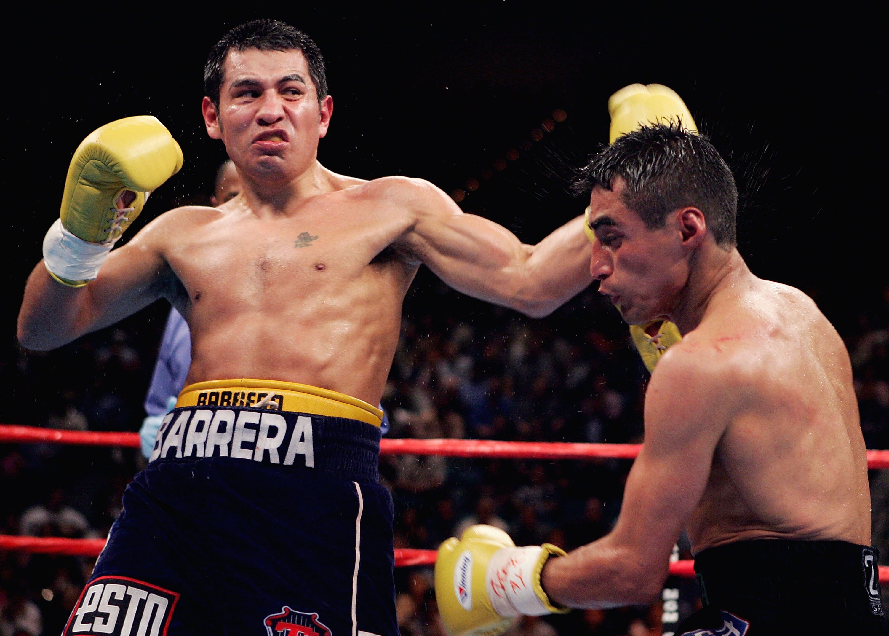 LAS VEGAS - NOVEMBER 27:  Marco Antonio Barrera (L) lands a left handed hook to the head of Erik Morales during a fight for the WBC World Super Featherweight Championship at the MGM Grand Garden Arena on November 27, 2004 in Las Vegas, Nevada. Barrera def