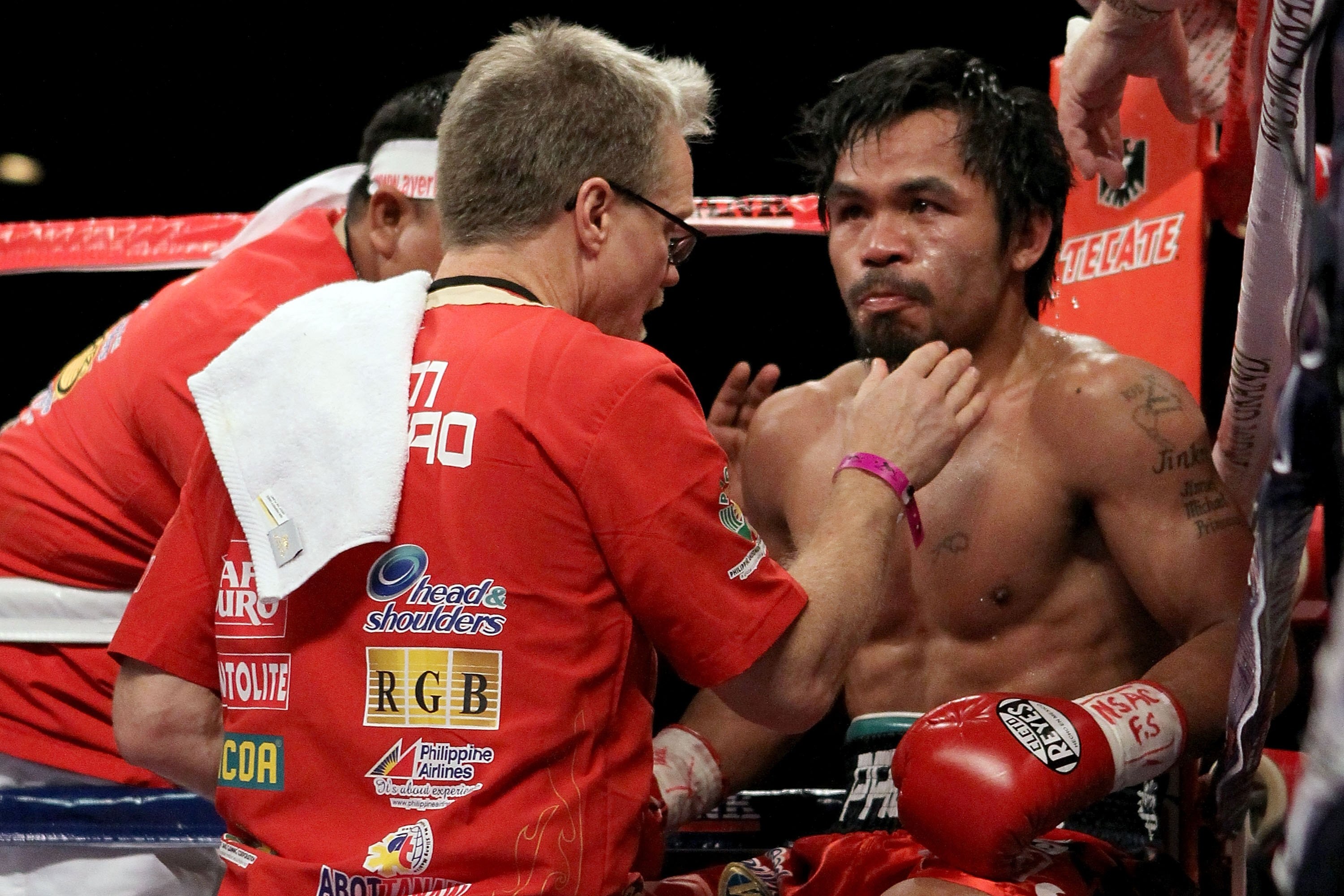 LAS VEGAS - NOVEMBER 14:  Manny Pacquiao sits in his corner between rounds with trainer Freddie Roach against Miguel Cotto during their WBO welterweight title fight at the MGM Grand Garden Arena on November 14, 2009 in Las Vegas, Nevada.  (Photo by Al Bel