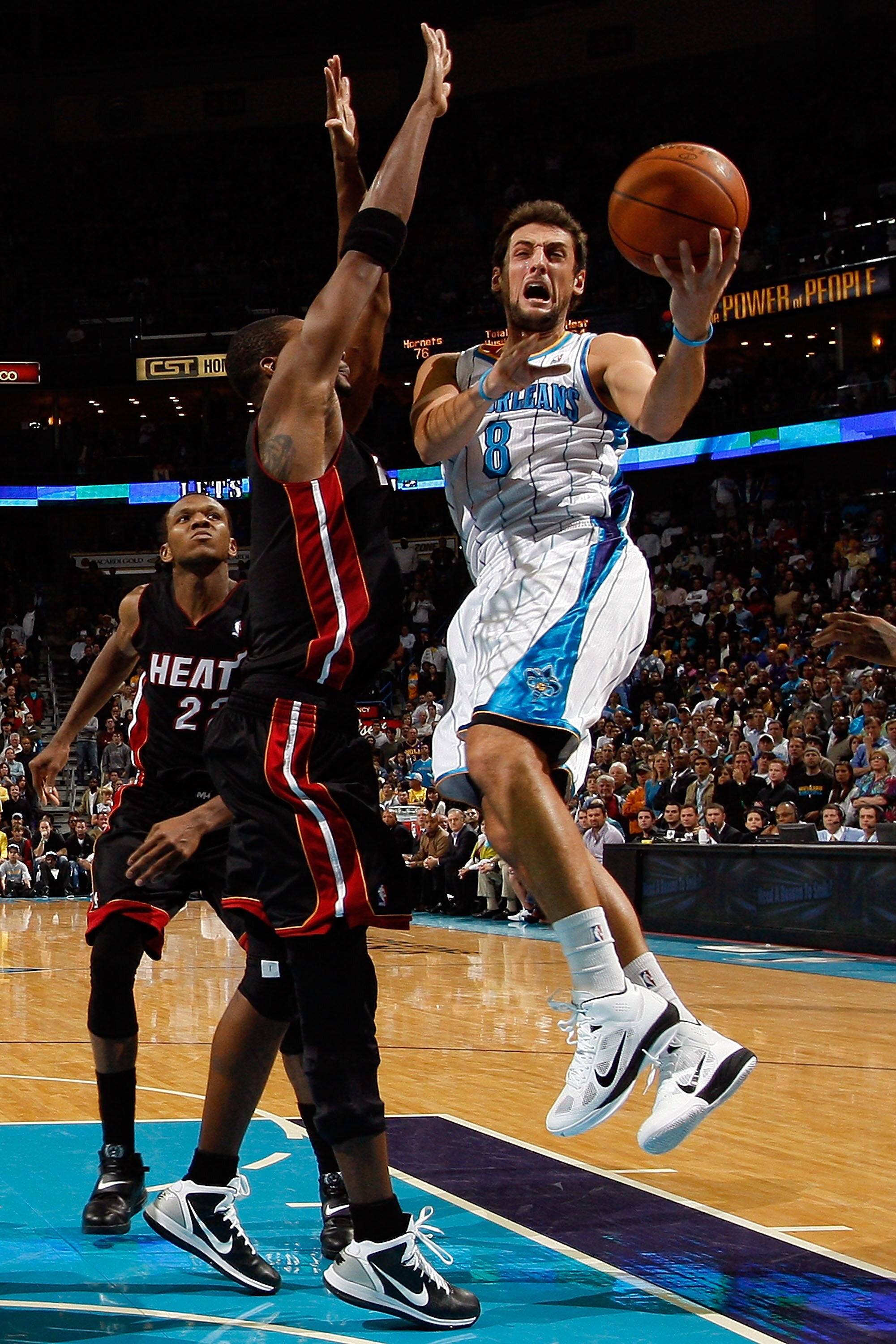 NEW ORLEANS - NOVEMBER 05:  Marco Belinelli #8 of the New Orleans Hornets shoots the ball over Chris Bosh #1 of the Miami Heat at the New Orleans Arena on November 5, 2010 in New Orleans, Louisiana.  The Hornets defeated the Heat 96-93.  NOTE TO USER: Use