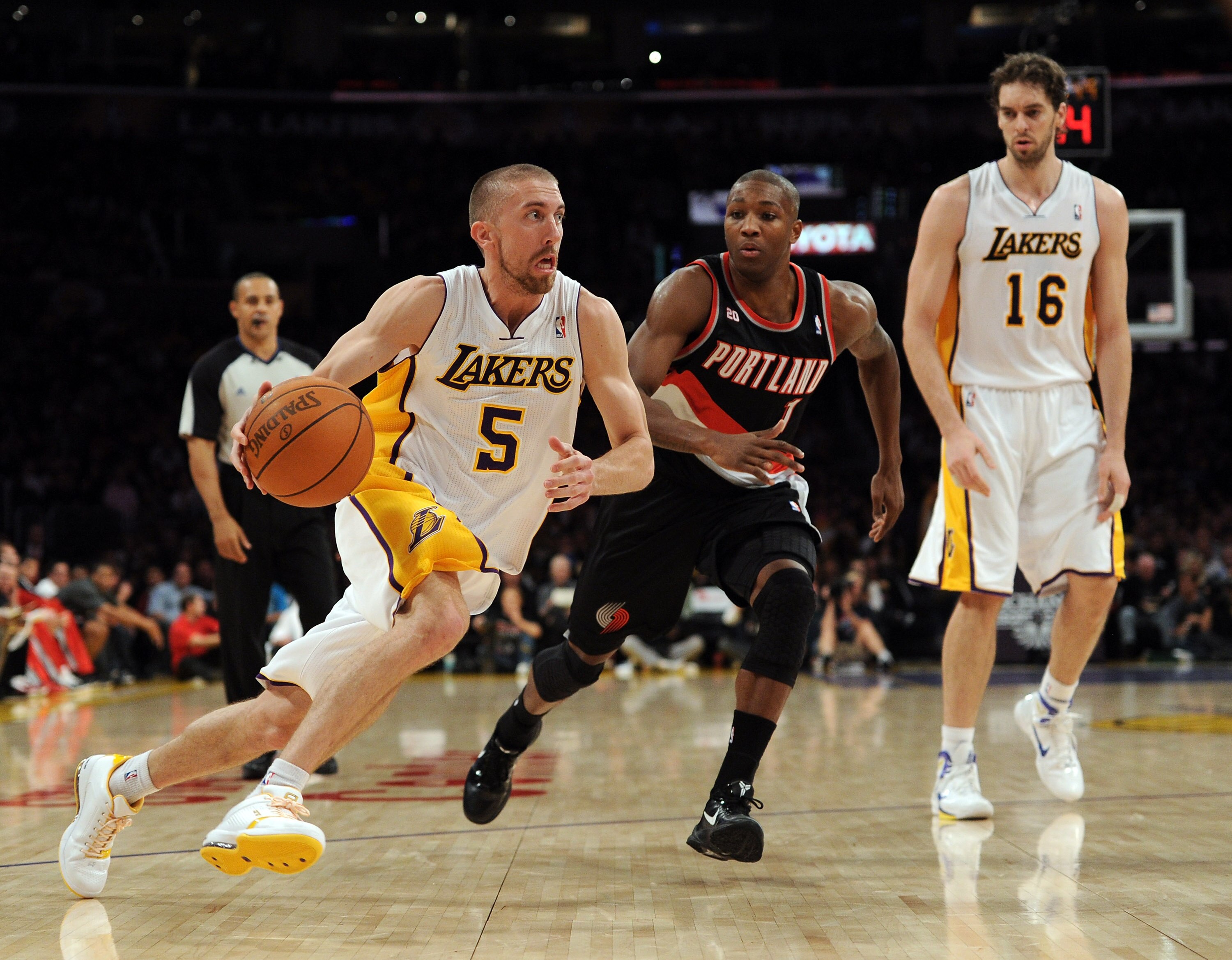 LOS ANGELES, CA - NOVEMBER 07:  Steve Blake #5 of the Los Angeles Lakers goes in for a layup past Armon Johnson #1 as Pau Gasol #16 looks on during the first half at the Staples Center on November 7, 2010 in Los Angeles, California.  NOTE TO USER: User ex