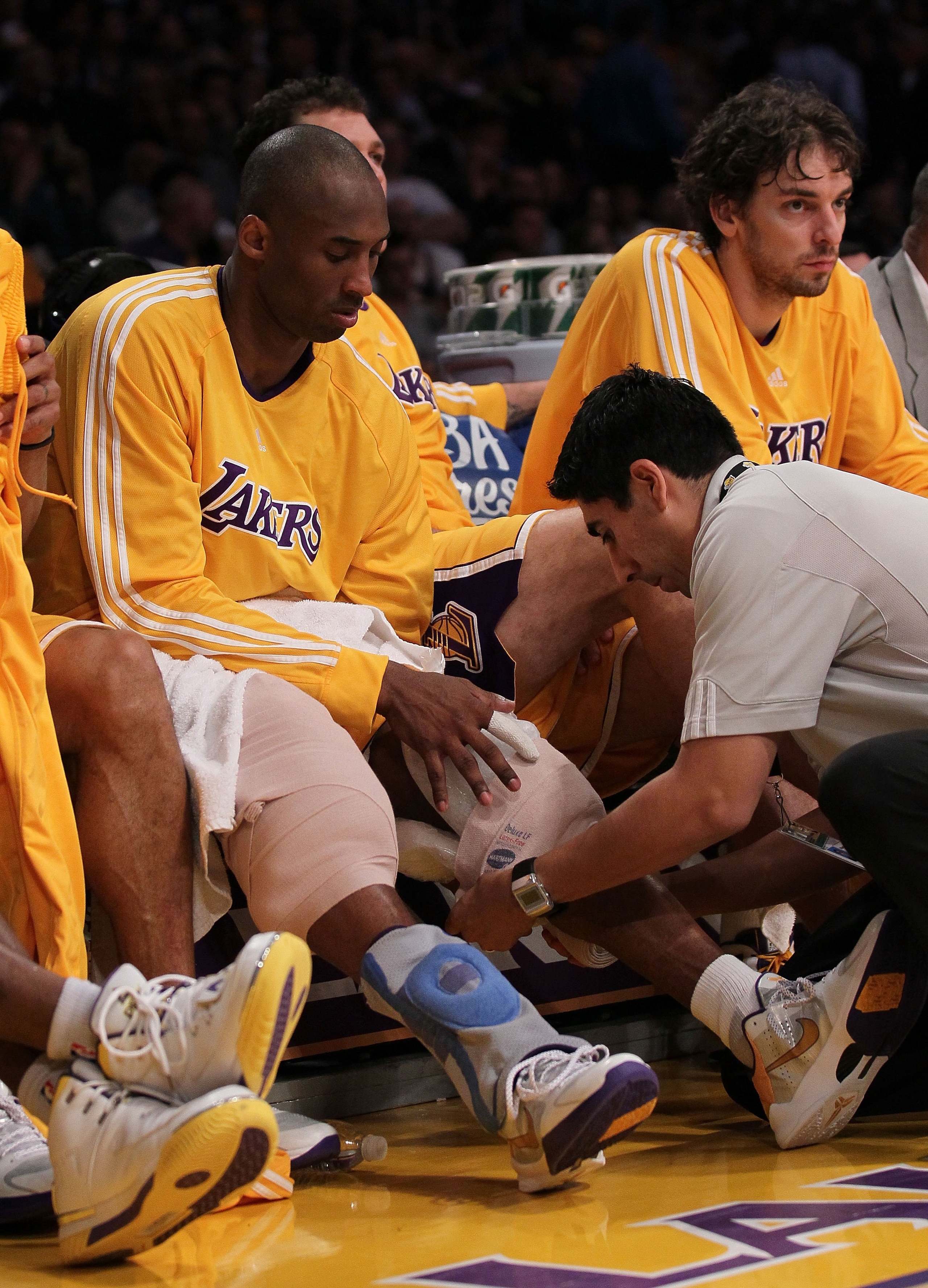 LOS ANGELES, CA - APRIL 27:  Kobe Bryant #24 of the Los Angeles Lakers has ice applied to his knees in the fourth quarter while taking on the Oklahoma City Thunder during Game Five of the Western Conference Quarterfinals of the 2010 NBA Playoffs at Staple