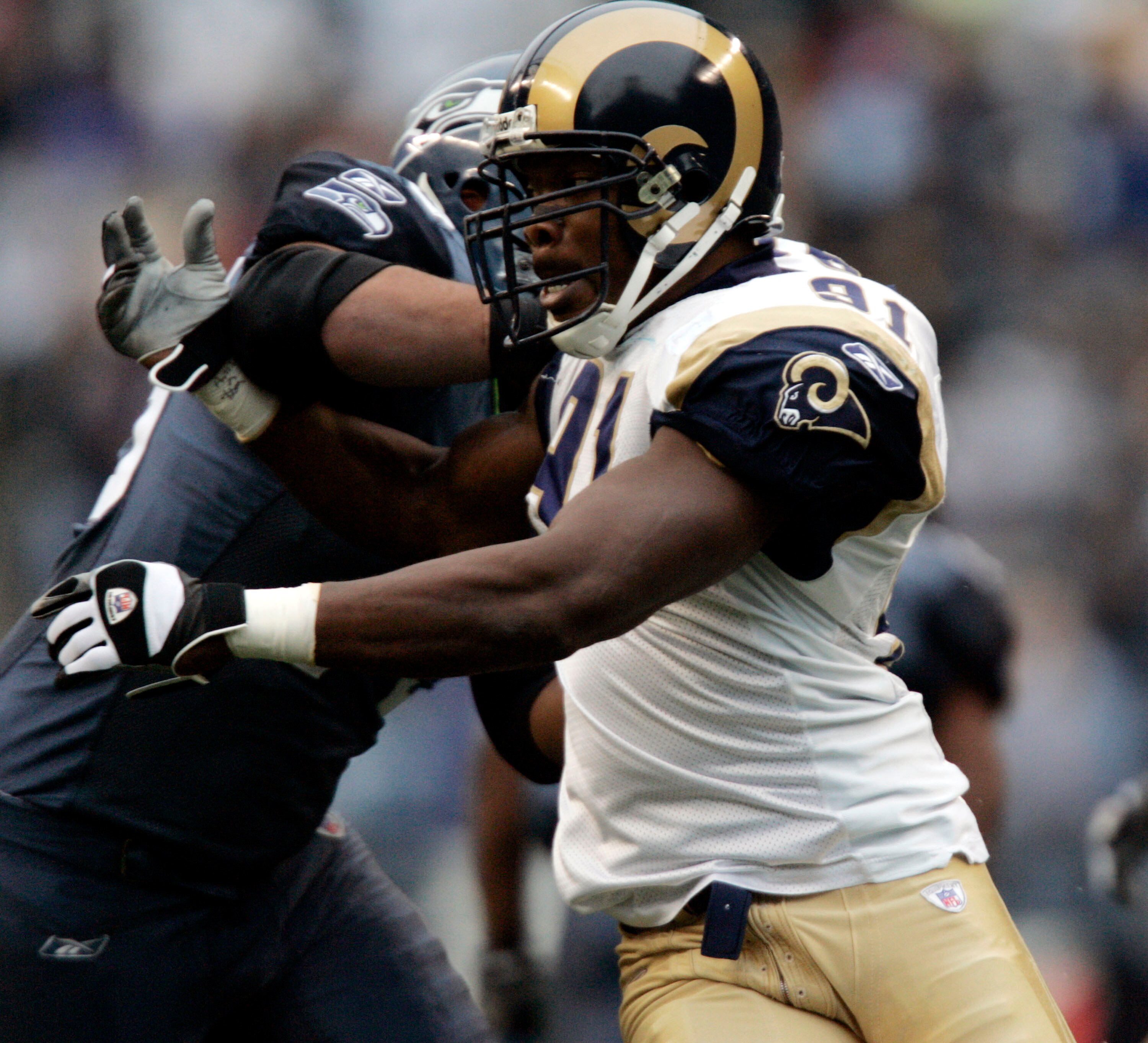 SEATTLE - NOVEMBER 13:  Left end Leonard Little #91 of the St. Louis Rams rushes against right tackle Sean Locklear #75 of the Seattle Seahawks at Qwest Field on November 13, 2005 in Seattle, Washington.  (Photo by Otto Greule Jr/Getty Images)