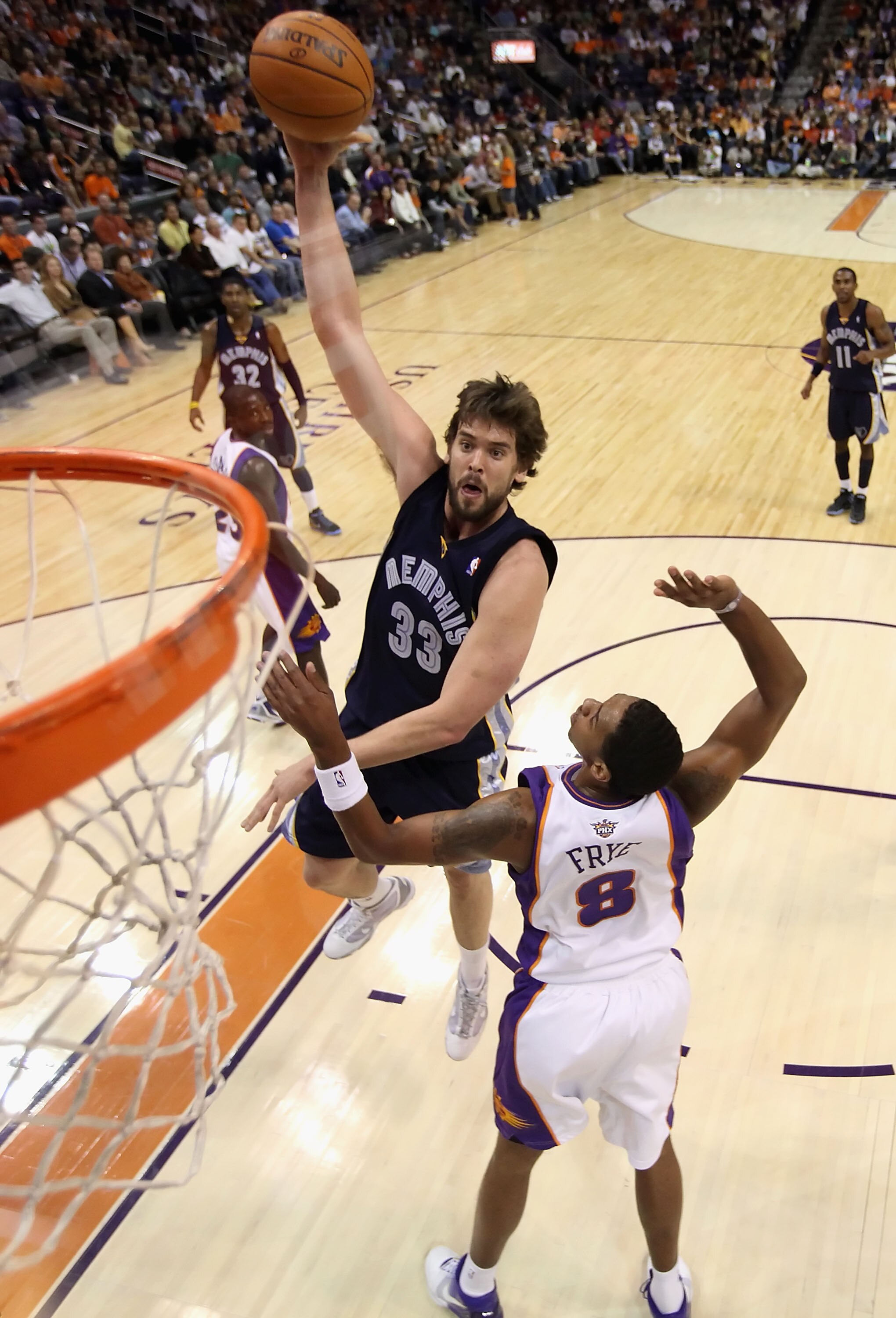 PHOENIX - NOVEMBER 25:  Marc Gasol #33 of the Memphis Grizzlies lays up a shot over Channing Frye #8 of the Phoenix Suns during the NBA game at US Airways Center on November 25, 2009 in Phoenix, Arizona. The Suns defeated the Grizzlies 126-111.  NOTE TO U