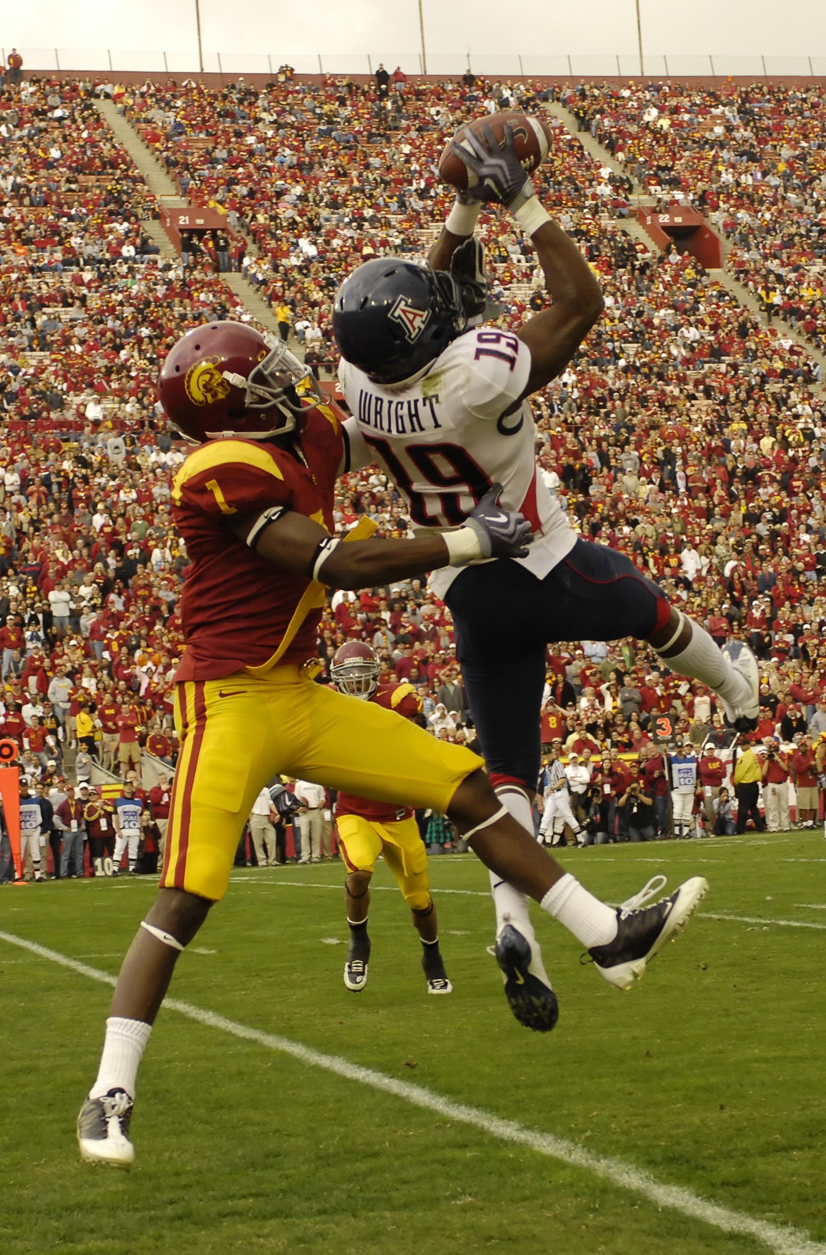 LOS ANGELES, CA - DECEMBER 05: Wide receiver William Wright #19 of the Arizona Wildcats catches a pass for a 19-yard gain against corner back T.J. Bryant #1 of the USC Trojans on the two yard line during the second quarter of the NCAA college football gam
