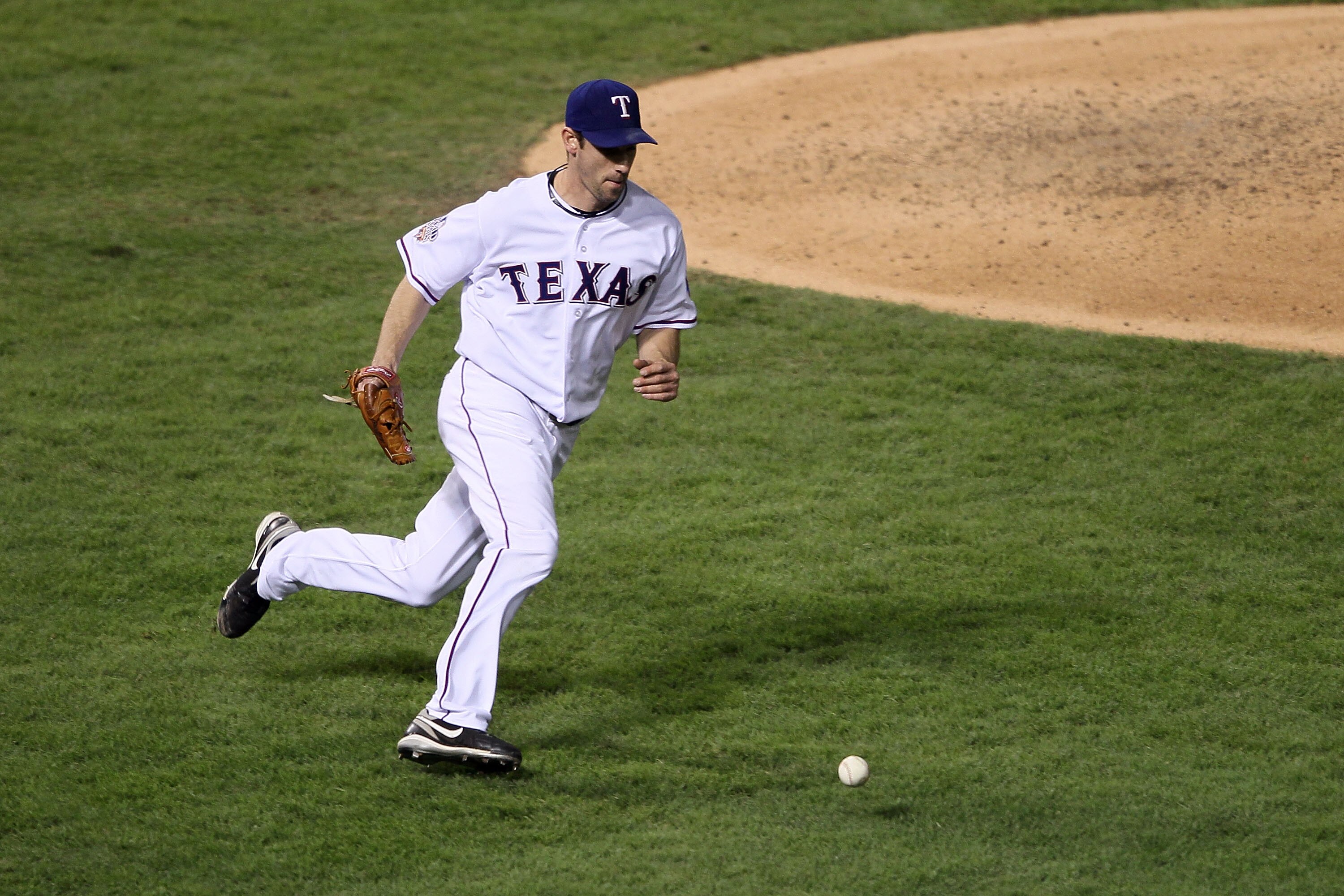 ARLINGTON, TX - NOVEMBER 01:  Cliff Lee #33 of the Texas Rangers tosses over to first for the out after a sac bunt by Aubrey Huff of the San Francisco Giants in Game Five of the 2010 MLB World Series at Rangers Ballpark in Arlington on November 1, 2010 in