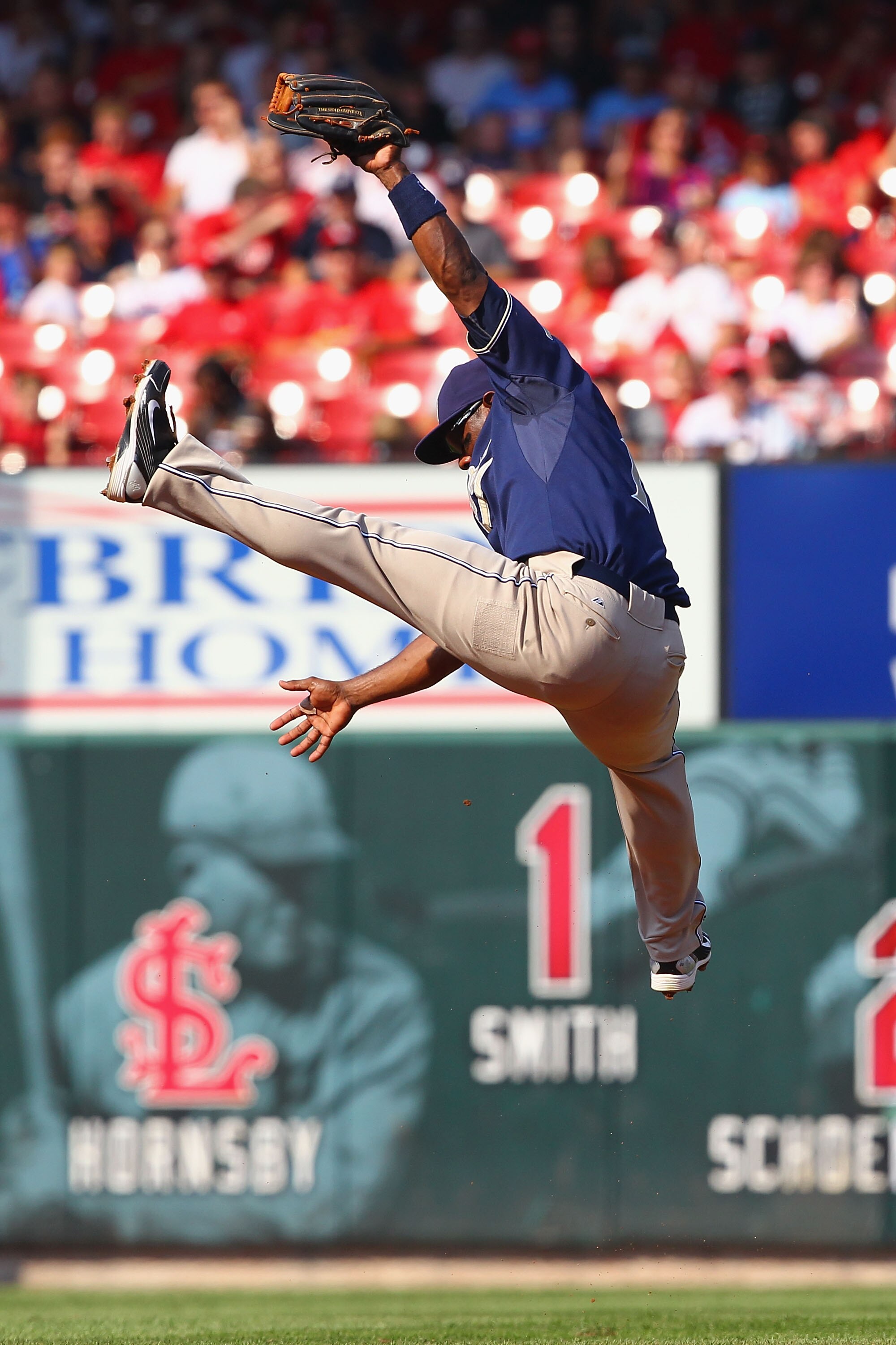ST. LOUIS - SEPTEMBER 18: Miguel Tejada #10 of the San Diego Padres attempts to catch a line drive against the St. Louis Cardinals at Busch Stadium on September 18, 2010 in St. Louis, Missouri.  The Padres beat the Cardinals 8-4.  (Photo by Dilip Vishwana