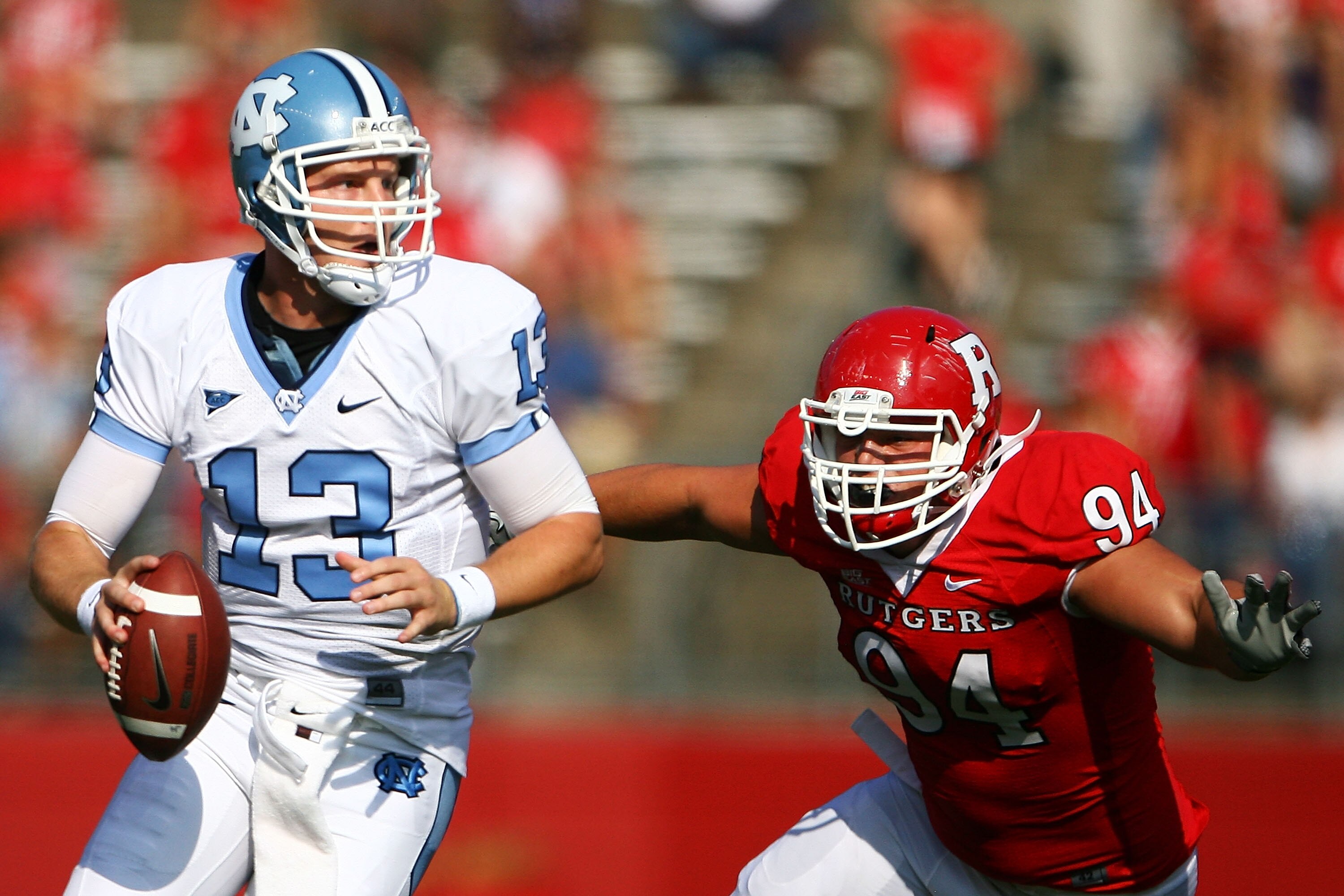 NEW BRUNSWICK, NJ - SEPTEMBER 25: Scott Vallone #94 of the Rutgers Scarlet Knights attempts to tackle T.J. Yates #13 of the North Carolina Tar Heels during a game at Rutgers Stadium on September 25, 2010 in New Brunswick, New Jersey. (Photo by Andrew B NEW BRUNSWICK, NJ - SEPTEMBER 25: Scott Vallone #94 of the Rutgers Scarlet Knights attempts to tackle T.J. Yates #13 of the North Carolina Tar Heels during a game at Rutgers Stadium on September 25, 2010 in New Brunswick, New Jersey. (Photo by Andrew B