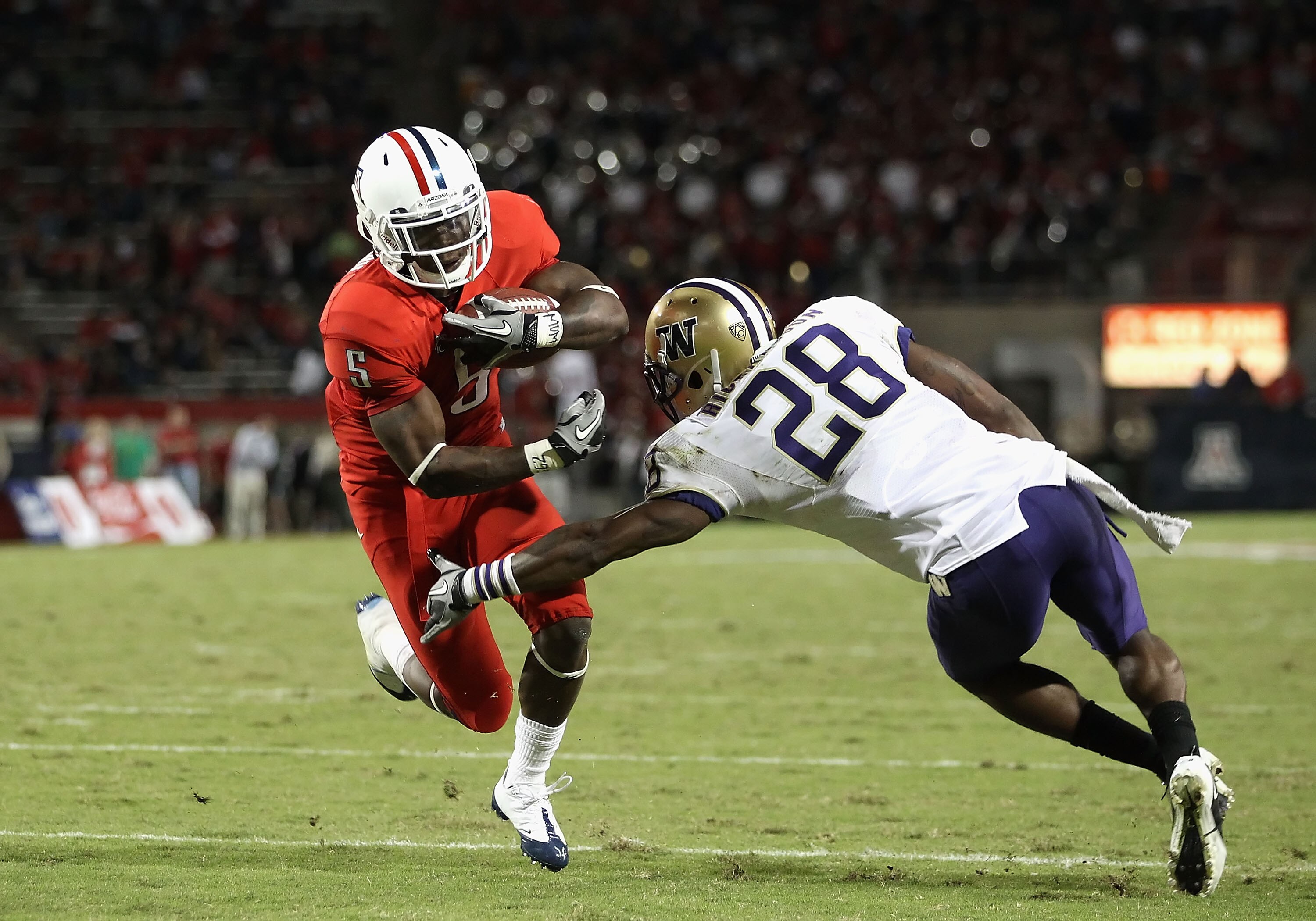 TUCSON, AZ - OCTOBER 23: Runningback Nic Grigsby #5 of the Arizona Wildcats runs with the ball during the college football game against the Washington Huskies at Arizona Stadium on October 23, 2010 in Tucson, Arizona. The Wildcats defeated the Huskies TUCSON, AZ - OCTOBER 23: Runningback Nic Grigsby #5 of the Arizona Wildcats runs with the ball during the college football game against the Washington Huskies at Arizona Stadium on October 23, 2010 in Tucson, Arizona. The Wildcats defeated the Huskies