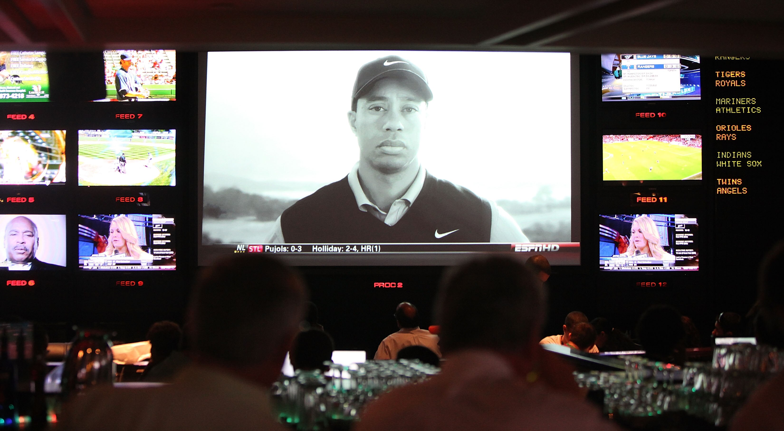 NEW YORK - APRIL 08:  Sports fans watch the controversial new Tiger Woods Nike advertisement featuring the voice of his late father Earl during Masters coverage televised at ESPN Zone April 8, 2010 in New York City. Woods is playing in the Masters for his