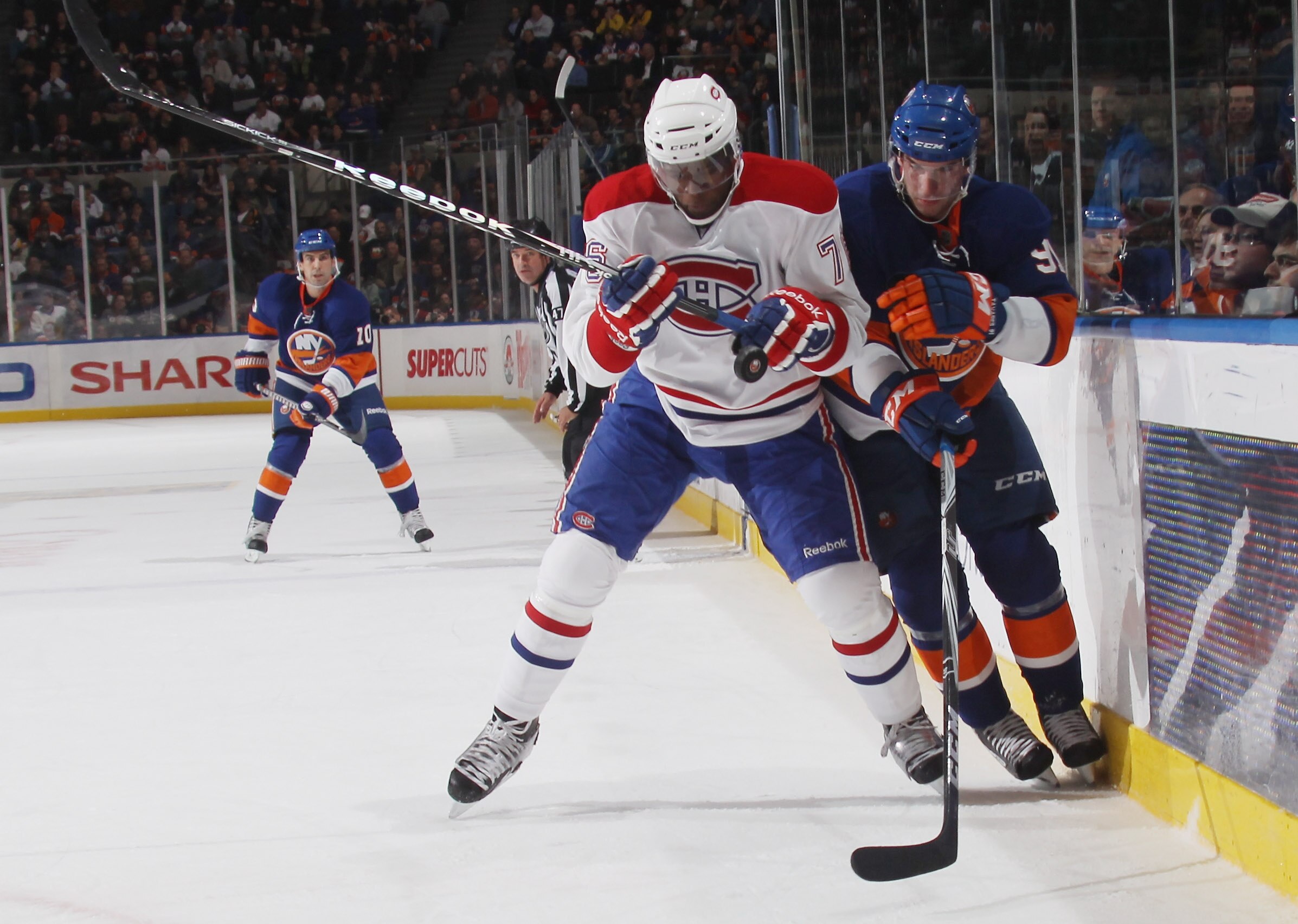 UNIONDALE, NY - OCTOBER 29: P.K. Subban #76 of the Montreal Canadiens squeezes John Tavares #91 of the New York Islanders into the boards at the Nassau Coliseum on October 29, 2010 in Uniondale, New York. (Photo by Bruce Bennett/Getty Images) UNIONDALE, NY - OCTOBER 29: P.K. Subban #76 of the Montreal Canadiens squeezes John Tavares #91 of the New York Islanders into the boards at the Nassau Coliseum on October 29, 2010 in Uniondale, New York. (Photo by Bruce Bennett/Getty Images)
