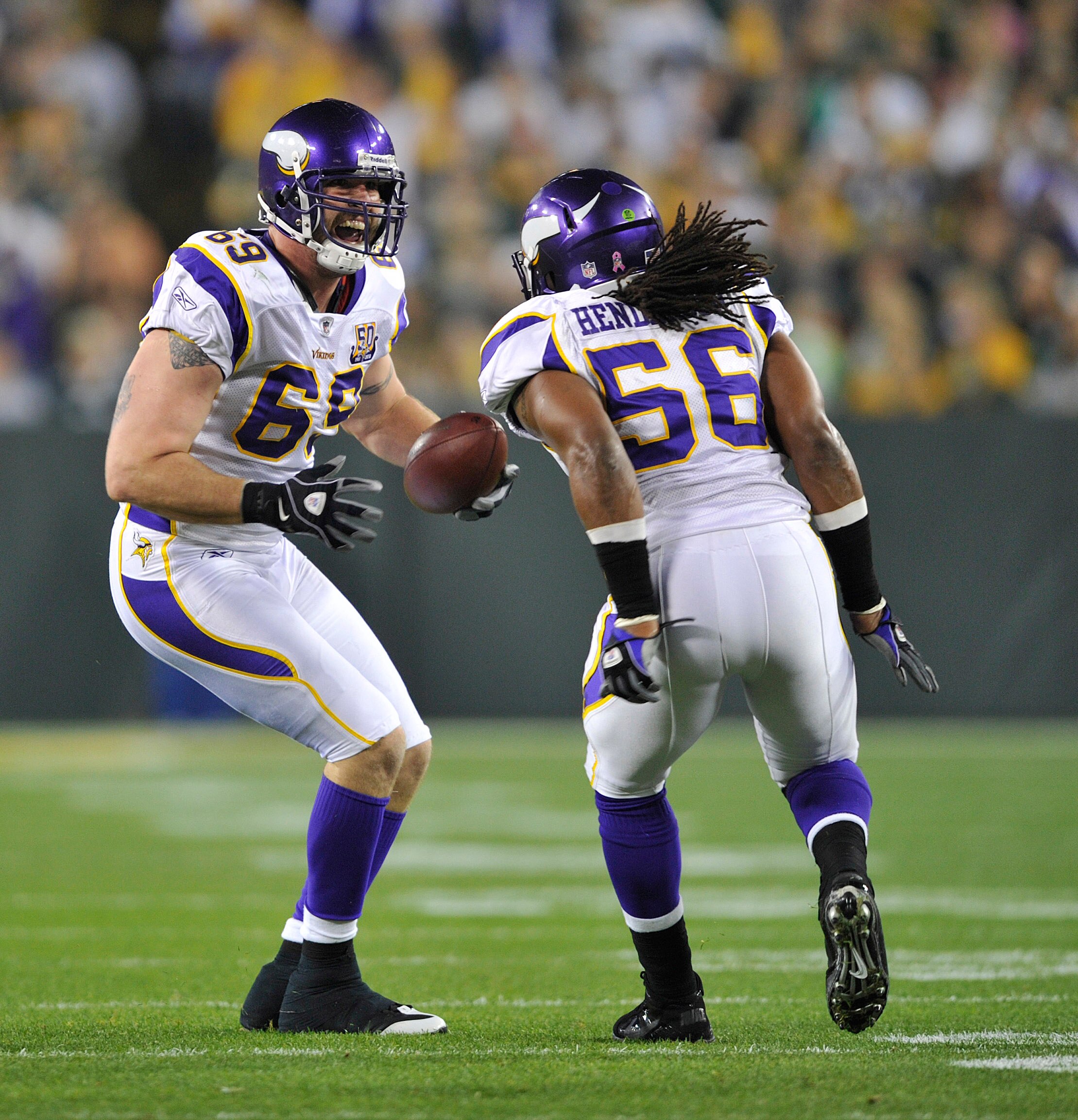 GREEN BAY, WI - OCTOBER 24:  Jared Allen #69 of the Minnesota Vikings celebrates with E.J. Henderson #56 after Allens' interception against the Green Bay Packers at Lambeau Field on October 24, 2010 in Green Bay, Wisconsin. (Photo by Jim Prisching/Getty I