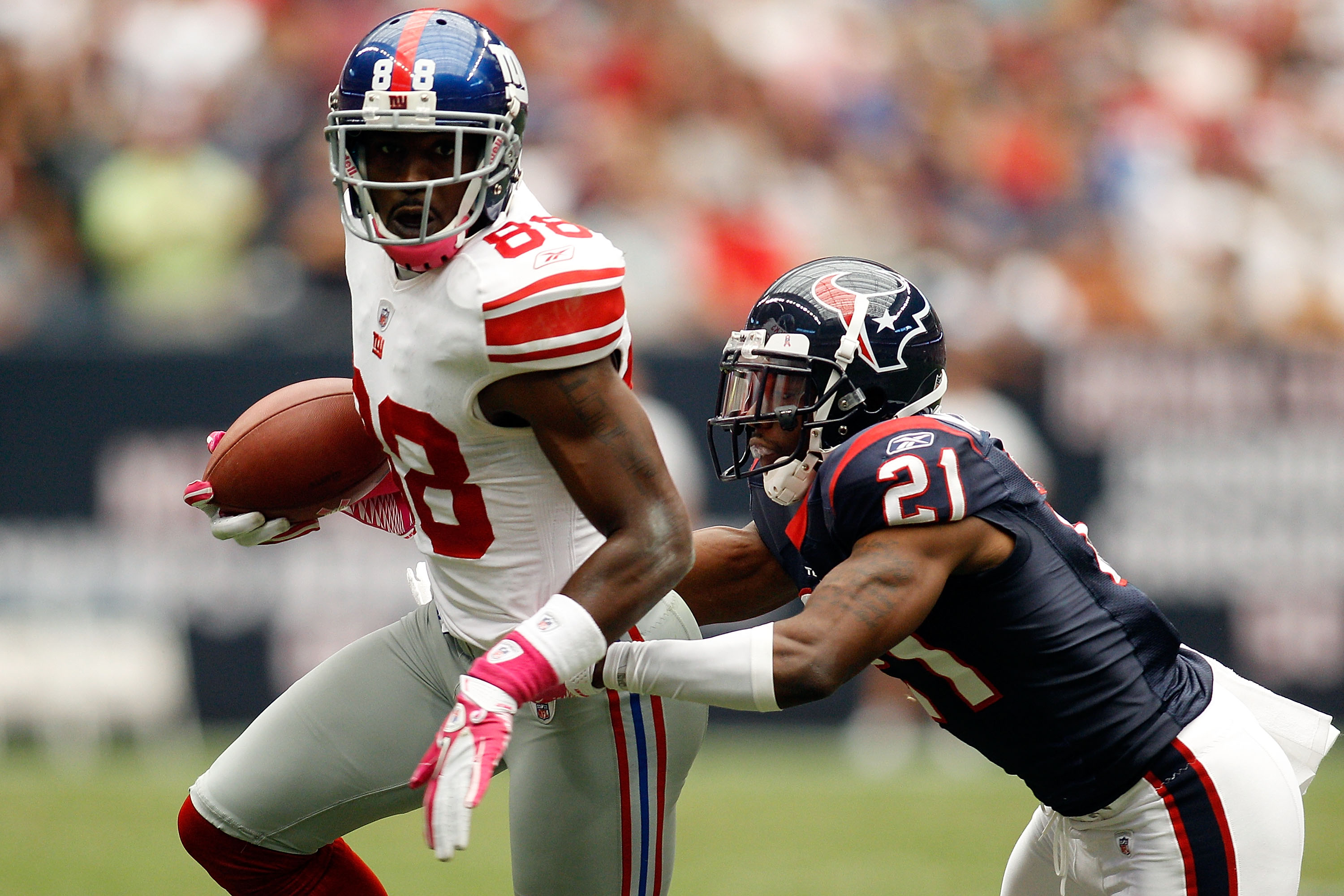 HOUSTON - OCTOBER 10:  Hakeem Nicks #88 of the New York Giants is tackled by Brice McCain #21 of the Houston Texans at Reliant Stadium on October 10, 2010 in Houston, Texas.  (Photo by Chris Graythen/Getty Images)