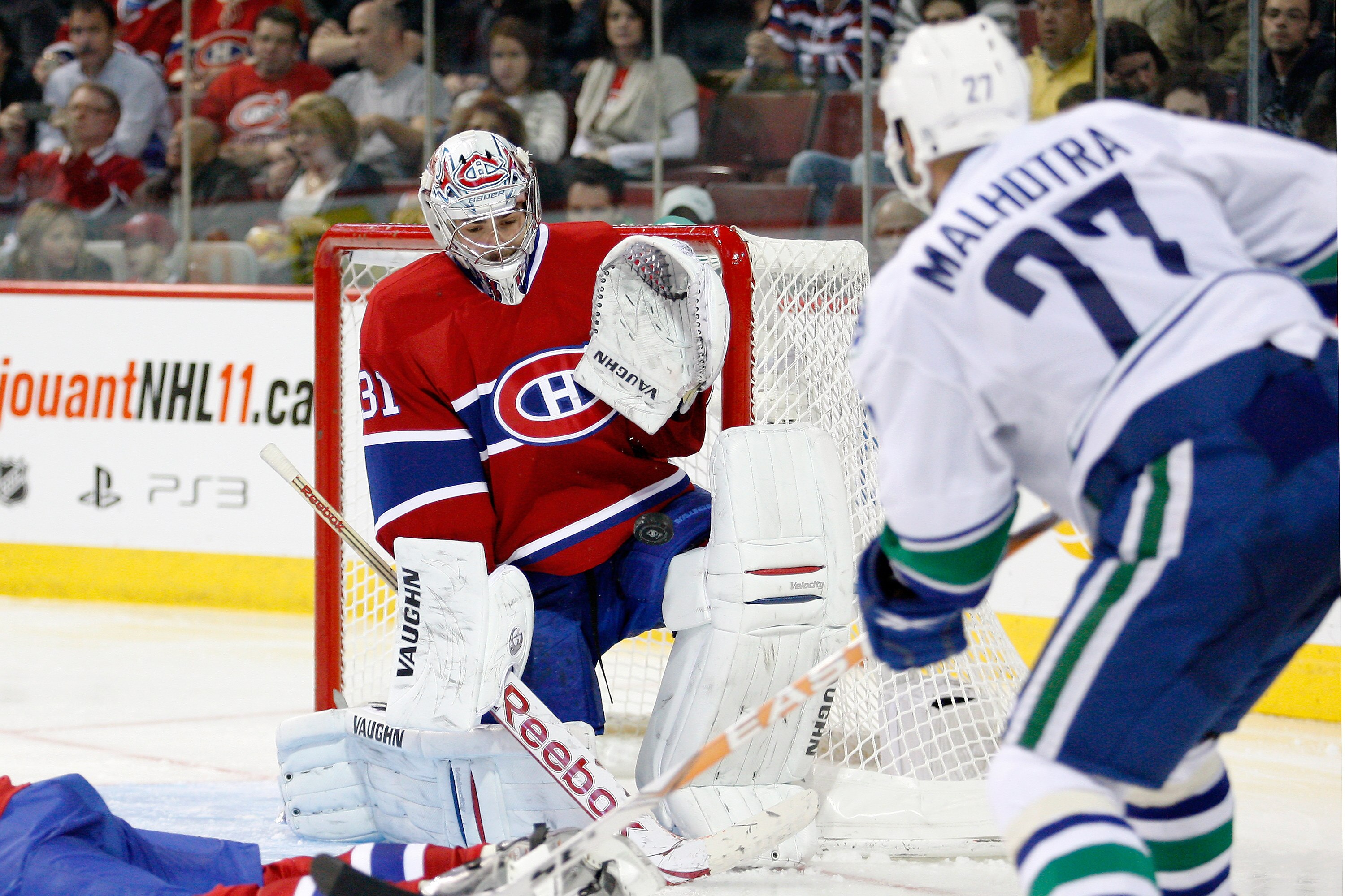 MONTREAL- NOVEMBER 9:  Carey Price #31 of the Montreal Canadiens stops the puck on a shot by Manny Malhotra #27 of the Vancouver Canucks during the NHL game at the Bell Centre on November 9, 2010 in Montreal, Quebec, Canada.  The Canadiens defeated the Ca
