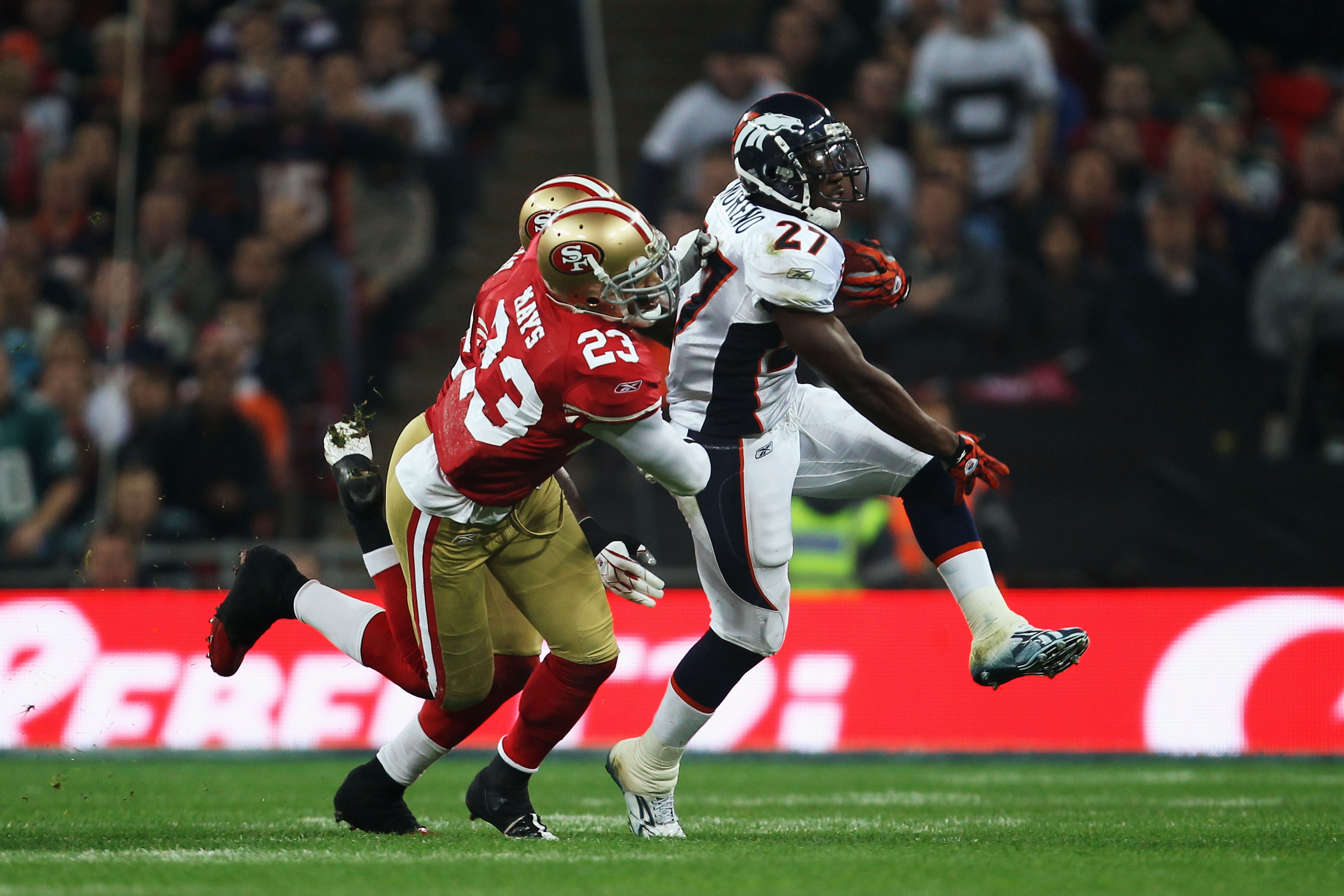 LONDON, ENGLAND - OCTOBER 31:  Knowshon Moreno #27 of Denver Broncos is tackled by Taylor Mays #23 of San Francisco 49ers during the NFL International Series match between Denver Broncos and San Francisco 49ers at Wembley Stadium on October 31, 2010 in Lo