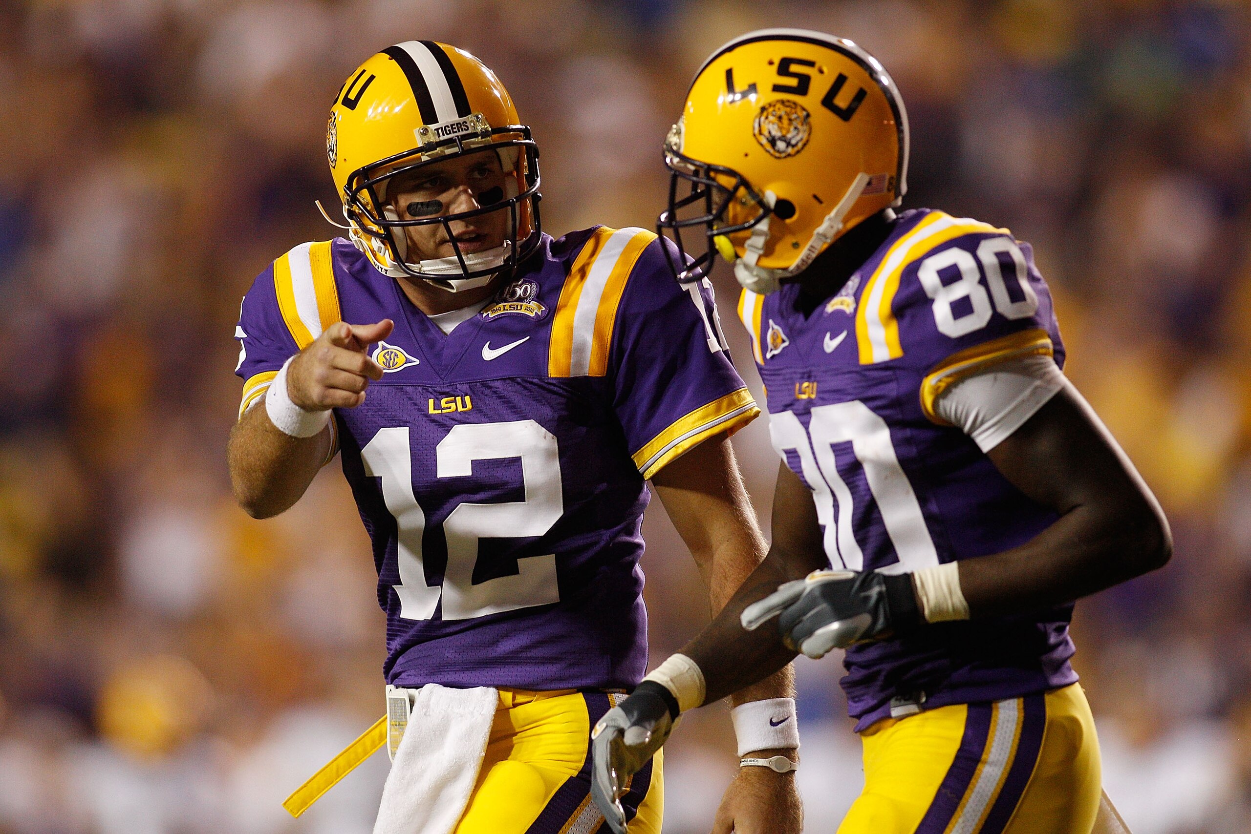 BATON ROUGE, LA - OCTOBER 16:  Jarrett Lee #12 talks with Terrence Toliver #80 of the Louisiana State University Tigers after a touchdown during the game against the McNeese State Cowboys at Tiger Stadium on October 16, 2010 in Baton Rouge, Louisiana.  (P