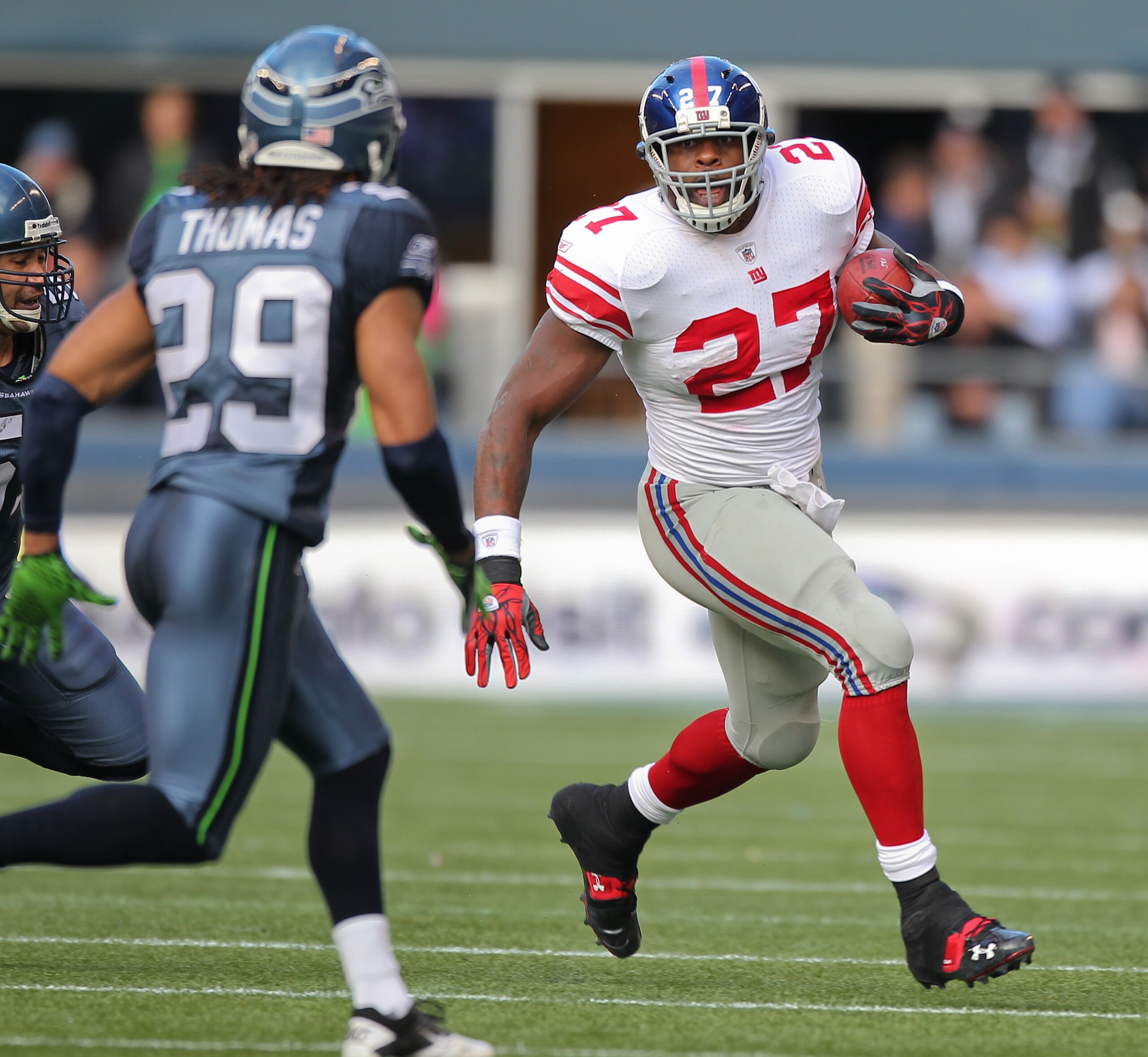 SEATTLE - NOVEMBER 07:  Running back Brandon Jacobs #27 of the New York Giants rushes against Earl Thomas #29 of the Seattle Seahawks at Qwest Field on November 7, 2010 in Seattle, Washington. The Giants defeated the Seahawks 41-7. (Photo by Otto Greule J