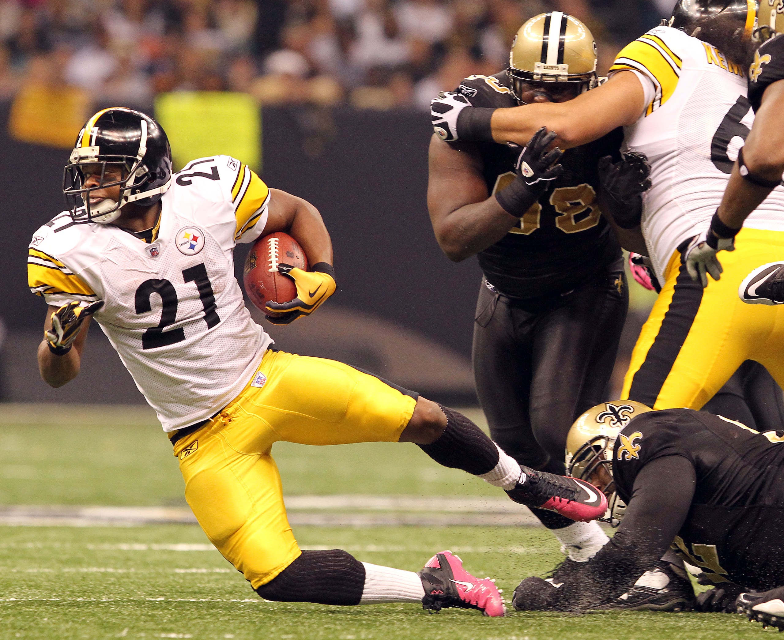 NEW ORLEANS - OCTOBER 31: Mewelde Moore #21 of the Pittsburgh Steelers is taken down by Remi Ayodele #92 of the New Orleans Saints at the Louisiana Superdome on October 31, 2010 in New Orleans, Louisiana. (Photo by Matthew Sharpe/Getty Images)