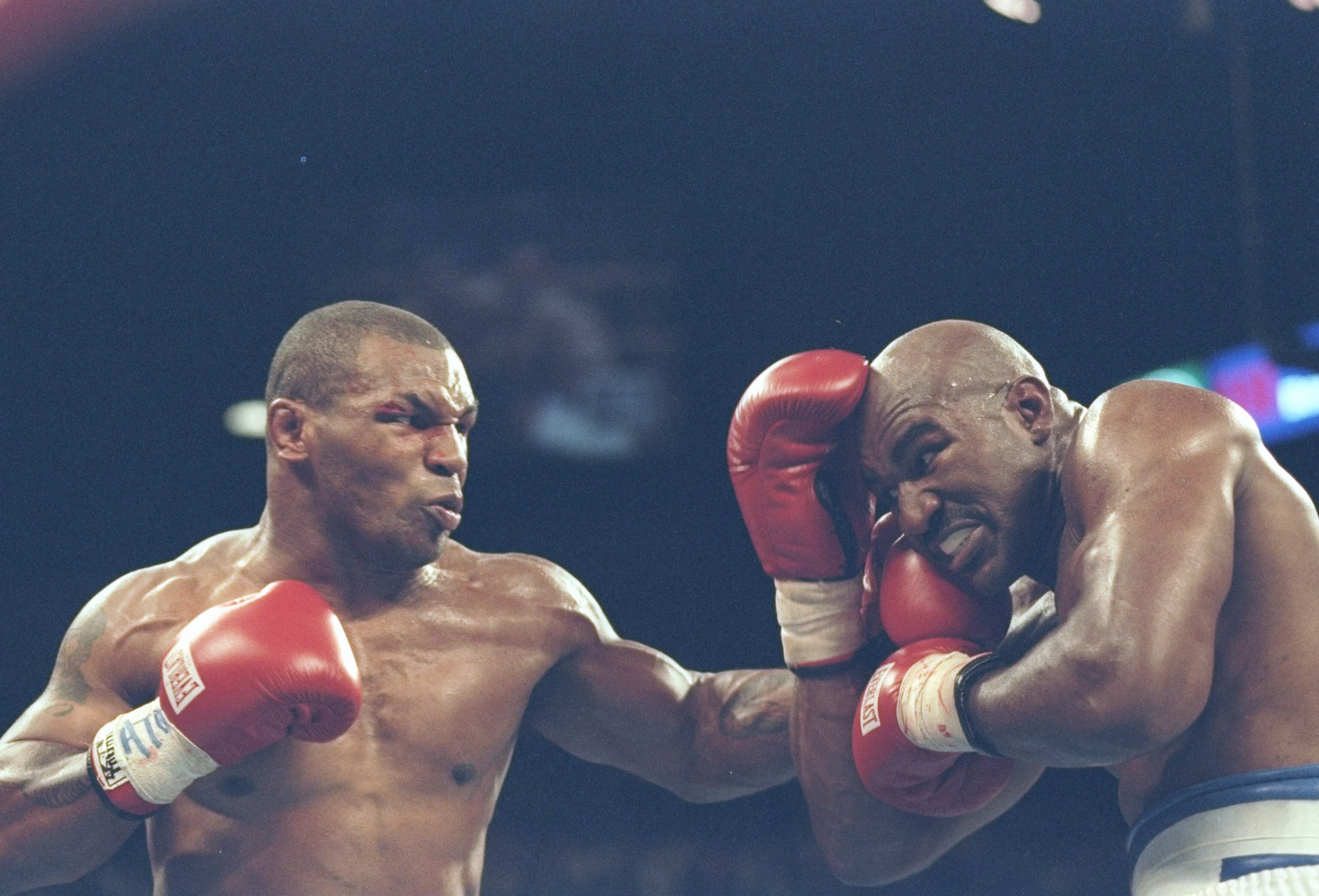 28 Jun 1997: Mike Tyson (L) lands a blow to the chin of Evander Holyfield during their bout against Mike Tyson at the MGM Grand Garden in Las Vegas, Nevada. Holyfield won the fight when referee Mills Lane disqualified Tyson in the third round after biting
