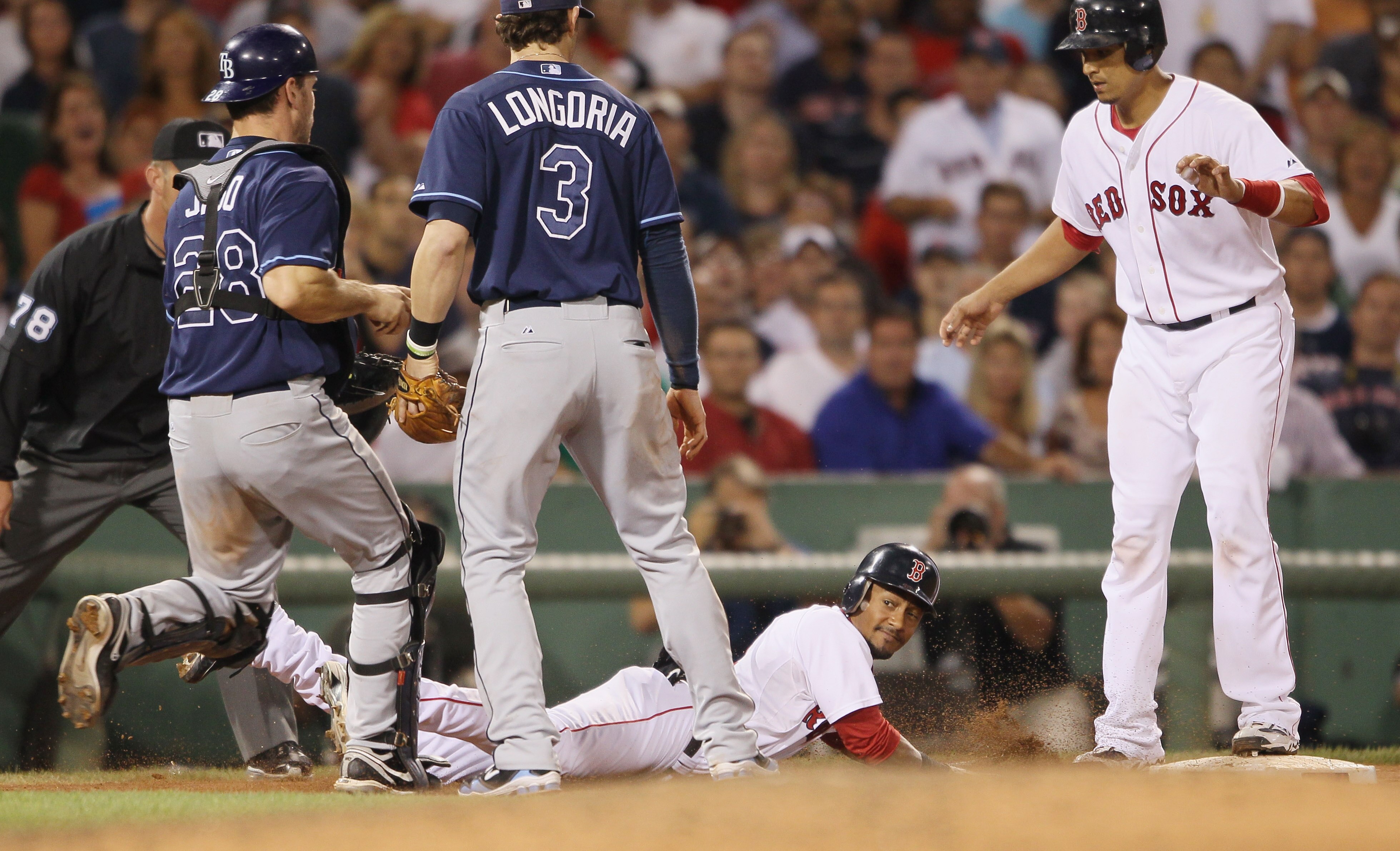 BOSTON - SEPTEMBER 08:  Eric Patterson #3 of the Boston Red Sox slides safely back to third as Evan Longoria #3 and John Jaso #28 of the Tampa Bay Rays chase him on September 8, 2010 at Fenway Park in Boston, Massachusetts. Patterson thought he was called