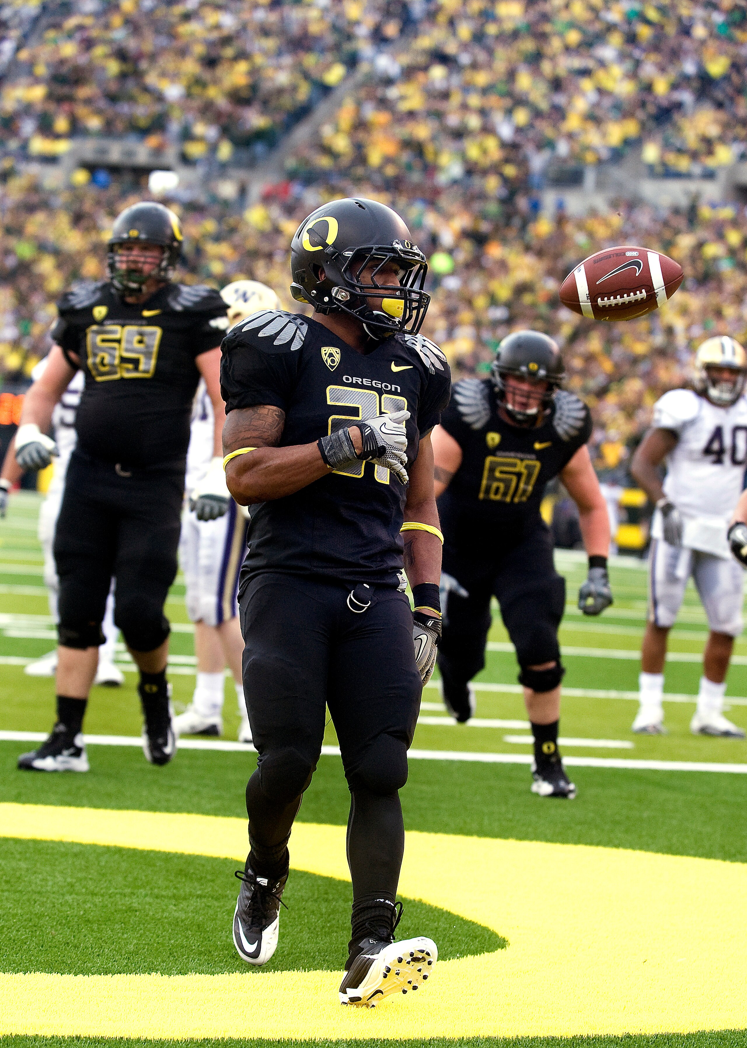 EUGENE, OR - NOVEMBER 6: Running back LaMichael James #21 of the Oregon Ducks tosses the ball to the official after scoring a touchdown in the fourth quarter of the game at Autzen Stadium on November 6, 2010 in Eugene, Oregon. The Ducks won the game 53-16