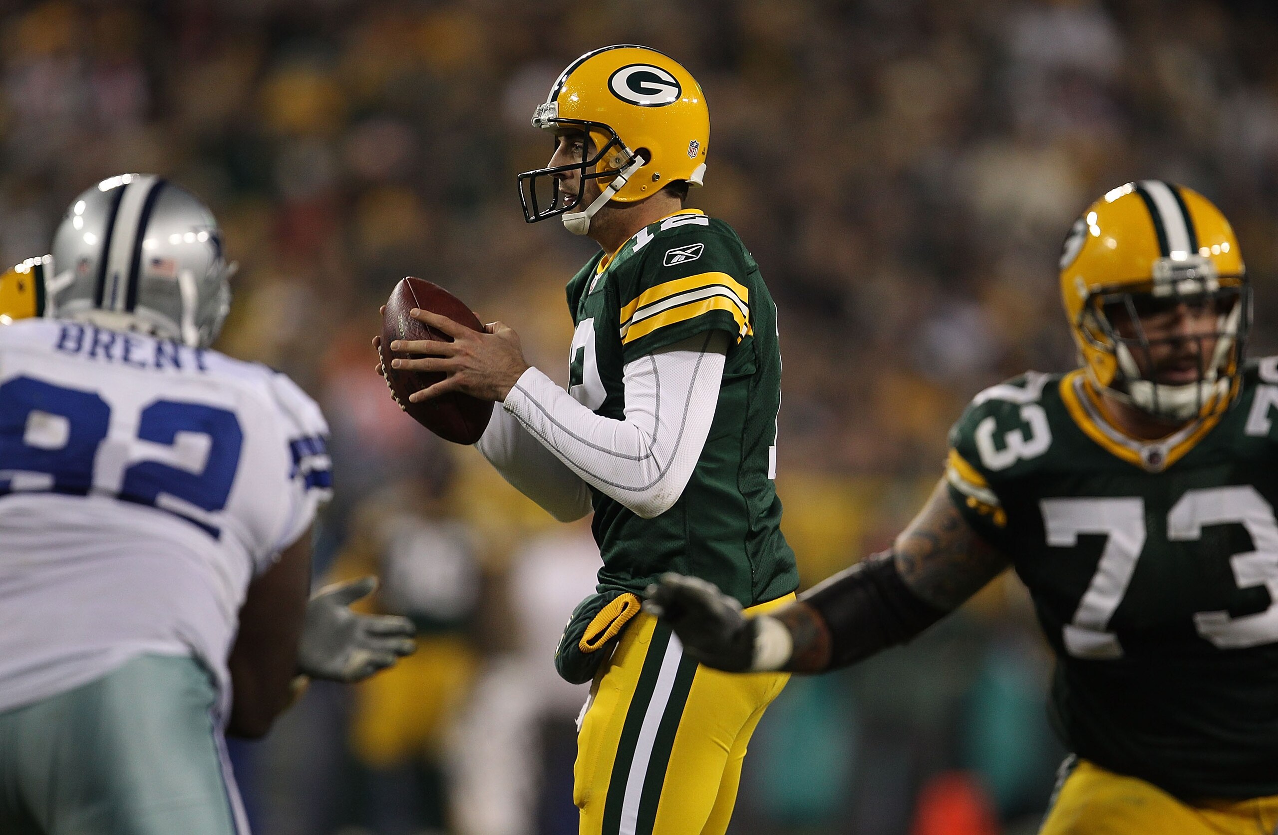 GREEN BAY, WI - NOVEMBER 07: Aaron Rodgers #12 of the Green Bay Packers takes the snap as teammate Daryn Colledge #73 looks to block and Josh Brent #92 of the Dallas Cowboys rushes at Lambeau Field on November 7, 2010 in Green Bay, Wisconsin. The Packers GREEN BAY, WI - NOVEMBER 07: Aaron Rodgers #12 of the Green Bay Packers takes the snap as teammate Daryn Colledge #73 looks to block and Josh Brent #92 of the Dallas Cowboys rushes at Lambeau Field on November 7, 2010 in Green Bay, Wisconsin. The Packers