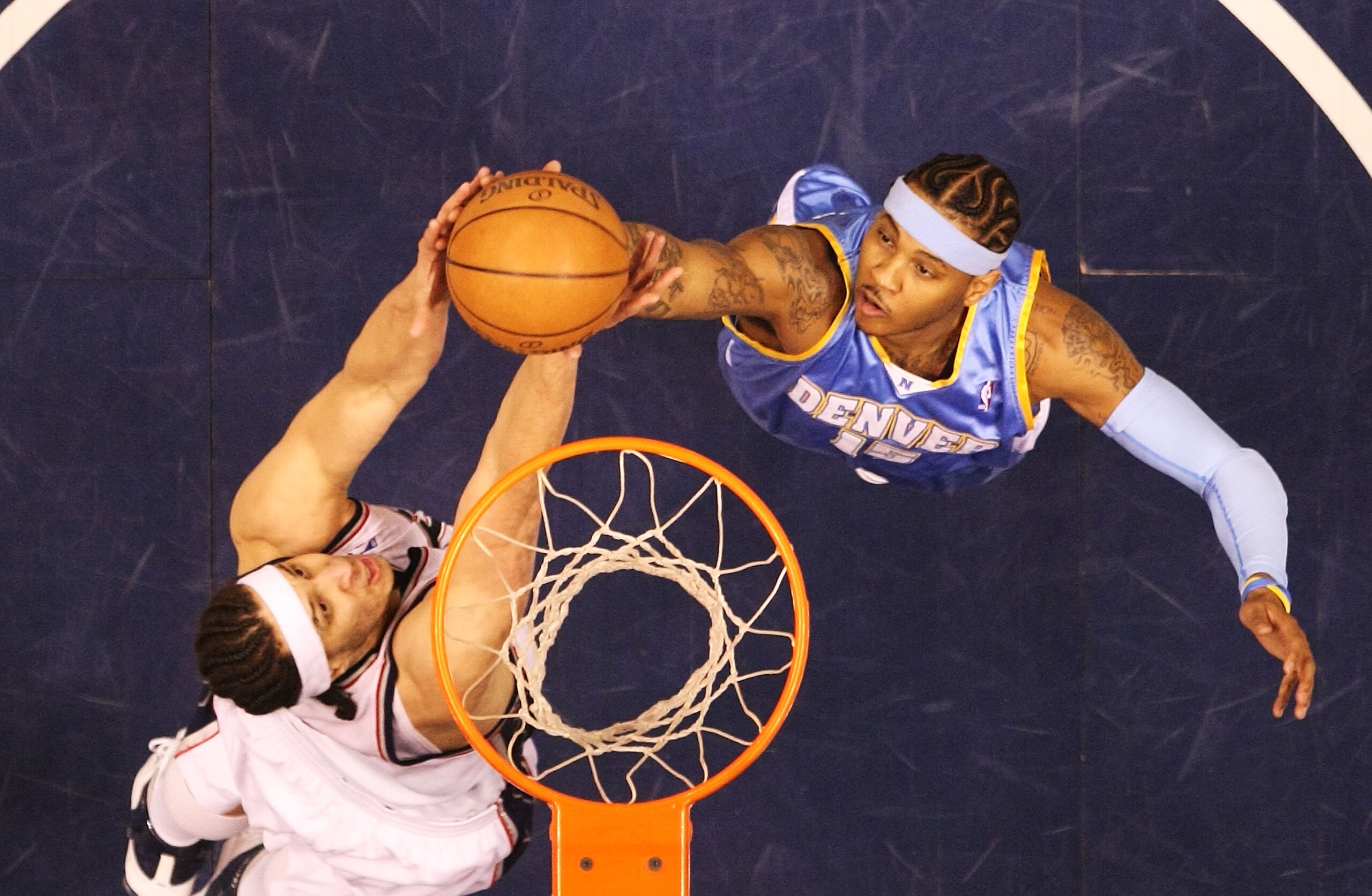EAST RUTHERFORD, NJ - MARCH 21:  Josh Boone #2 of the New Jersey Nets attempts to score as Carmelo Anthony #15 of the Denver Nuggets defends during their game on March 21, 2008 at the Izod Arena in East Rutherford, New Jersey.  Photo By Al Bello/Getty Ima