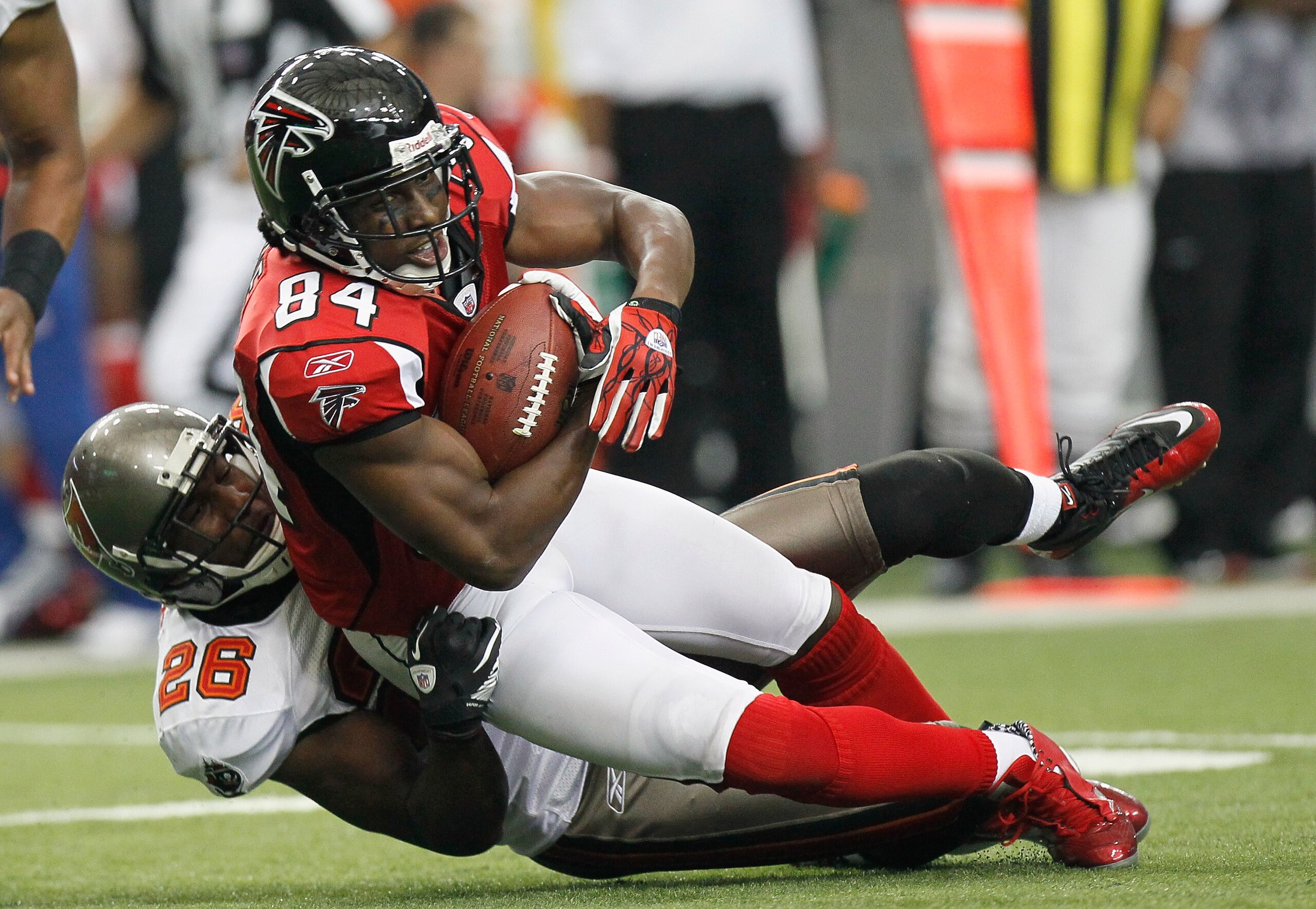ATLANTA - NOVEMBER 07:  Roddy White #84 of the Atlanta Falcons is tackled by Sean Jones #26 of the Tampa Bay Buccaneers at Georgia Dome on November 7, 2010 in Atlanta, Georgia.  (Photo by Kevin C. Cox/Getty Images)