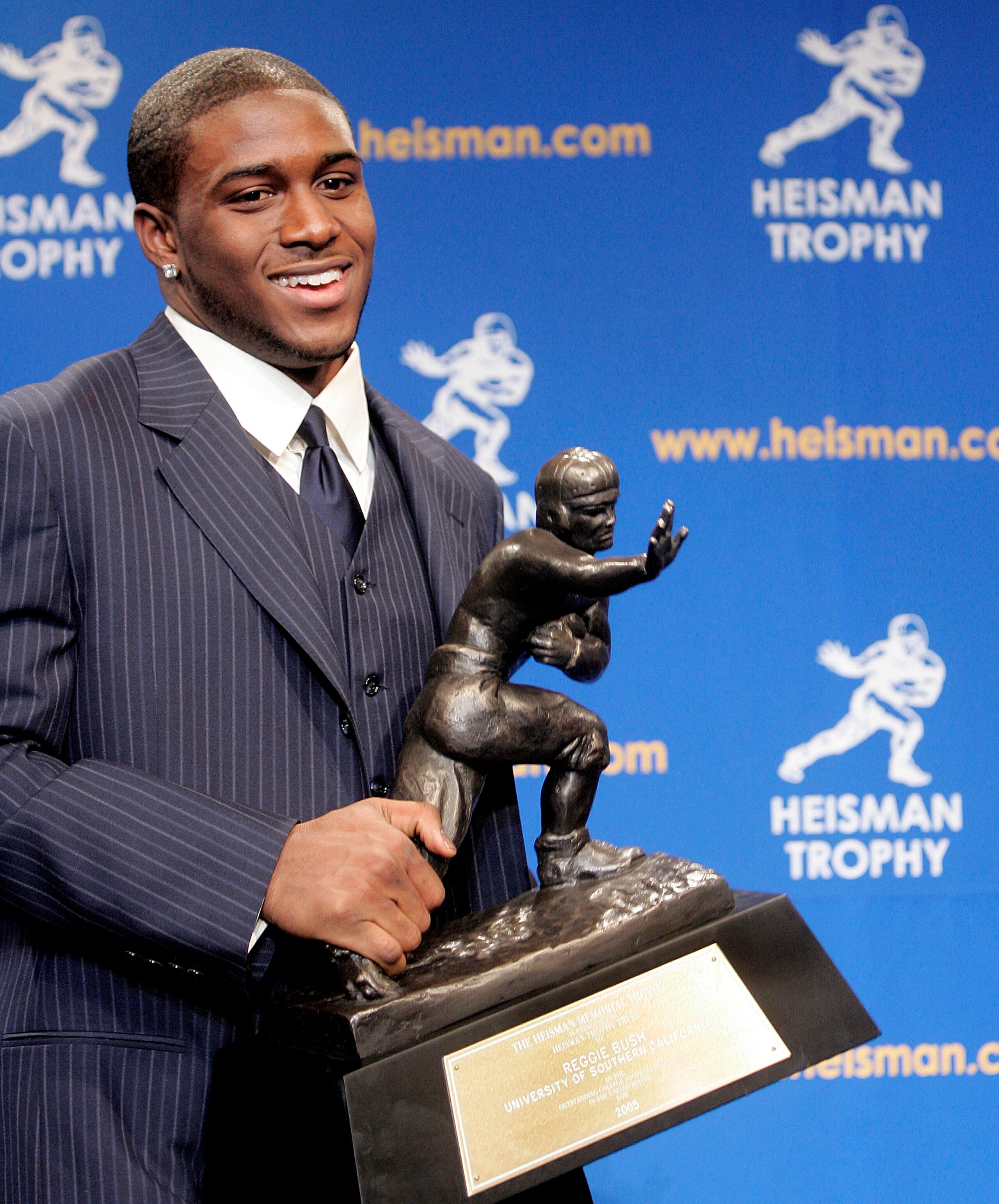 NEW YORK - DECEMBER 10: Running back Reggie Bush #5 of the USC Trojans poses with the 2005 Heisman trophy after winning the award at the 71st Annual Heisman Ceremony on December 10, 2005 in New York City. (Photo by Stephen Chernin/Getty Images) NEW YORK - DECEMBER 10: Running back Reggie Bush #5 of the USC Trojans poses with the 2005 Heisman trophy after winning the award at the 71st Annual Heisman Ceremony on December 10, 2005 in New York City. (Photo by Stephen Chernin/Getty Images)