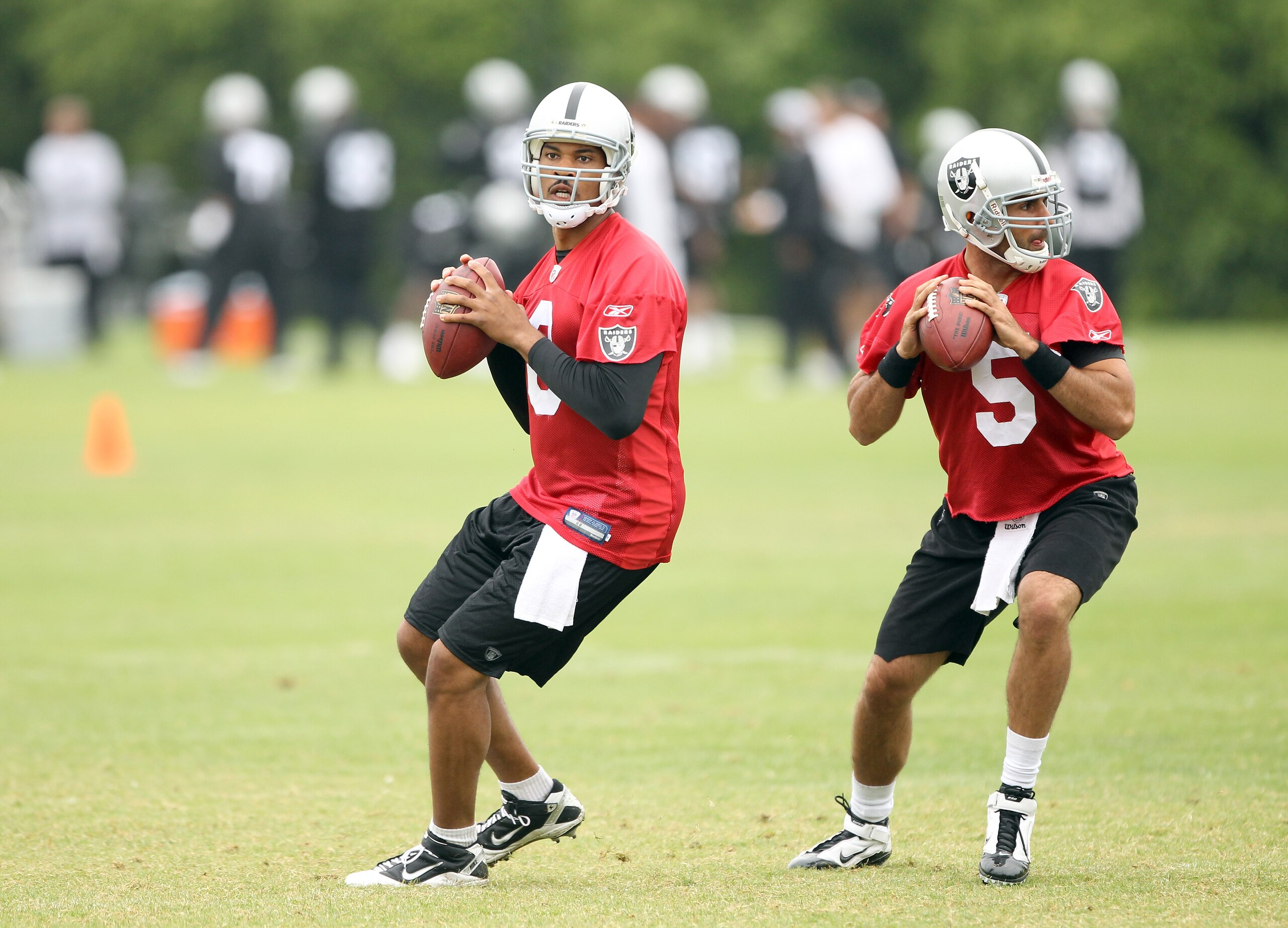 NAPA, CA - AUGUST 01:  Jason Campbell #8 and Bruce Gradkowski #5 of the Oakland Raiders work out during the Raiders training camp at their Napa Valley Training Complex on August 1, 2010 in Napa, California.  (Photo by Ezra Shaw/Getty Images)