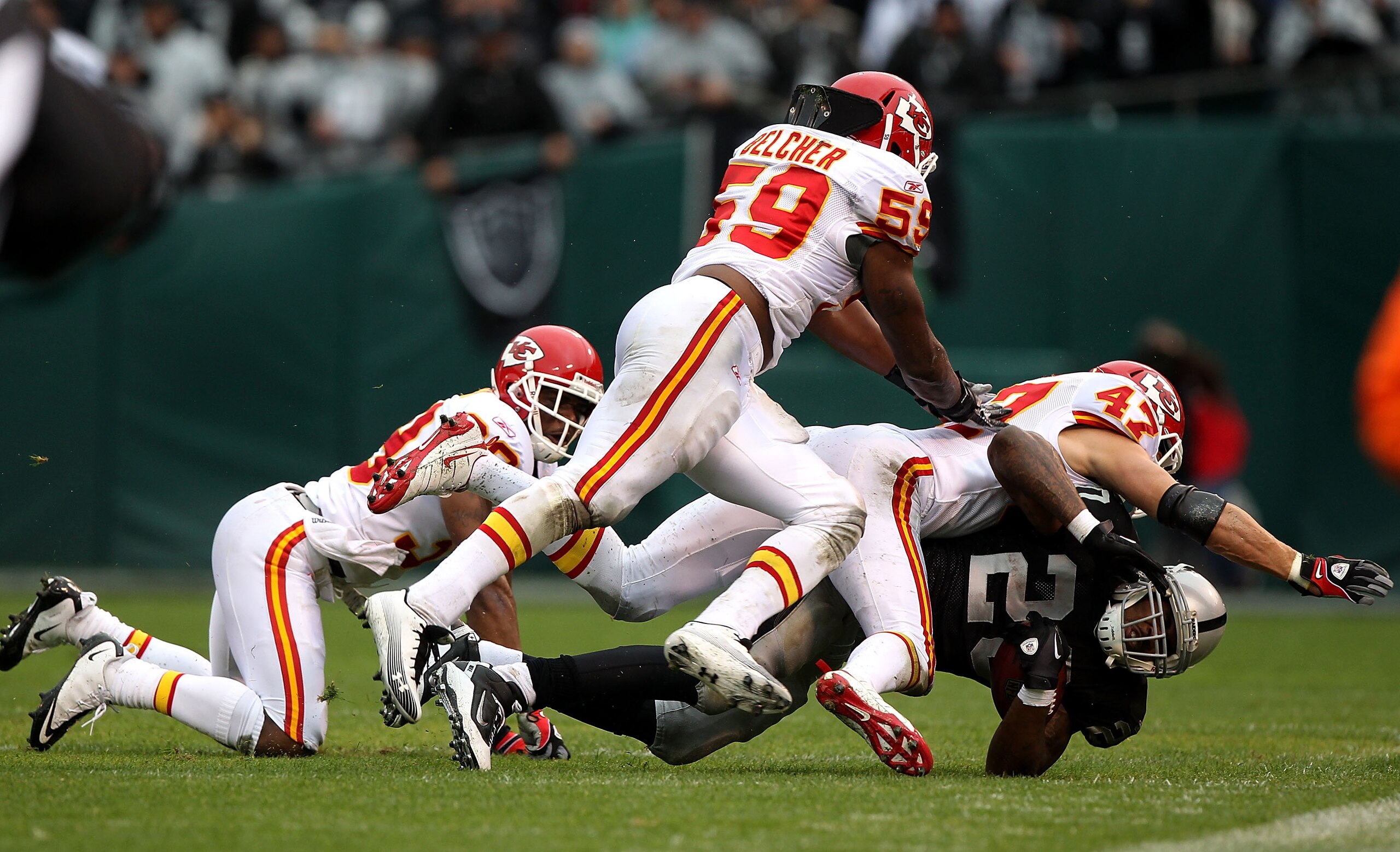 OAKLAND, CA - NOVEMBER 7:  Darren McFadden #20 of the Oakland Raiders is tackled by John McGraw #47 and Jovan Belcher #59 of the Kansas City Chiefs during an NFL game at Oakland-Alameda County Coliseum on November 7, 2010 in Oakland, California.  (Photo b