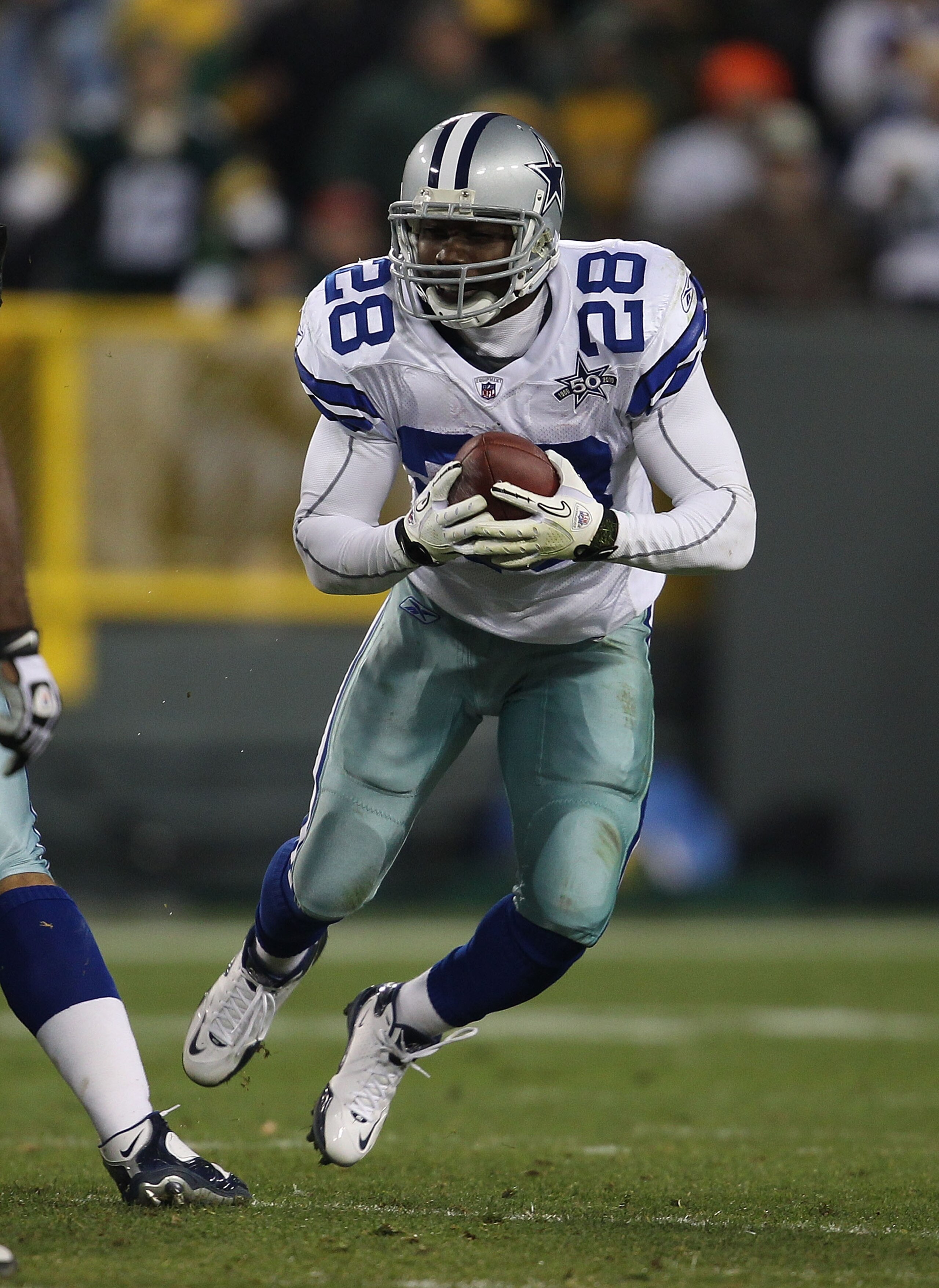 GREEN BAY, WI - NOVEMBER 07: Felix Jones #28 of the Dallas Cowboys runs after picking up a fumble against the Green Bay Packers at Lambeau Field on November 7, 2010 in Green Bay, Wisconsin. The Packers defeated the Cowboys 45-7. (Photo by Jonathan Daniel/