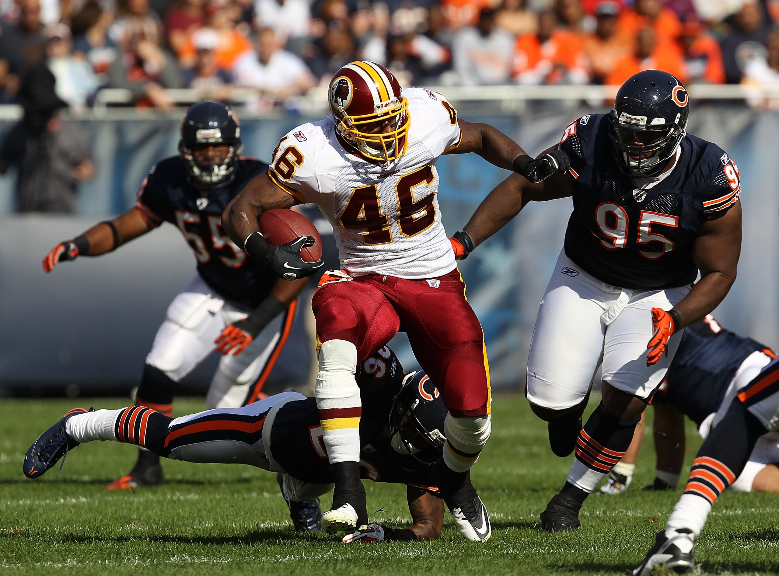 CHICAGO - OCTOBER 24: Ryan Torain #46 of the Washington Redskins runs past Tim Jennings #26 and Anthony Adams #95 of the Chicago Bears at Soldier Field on October 24, 2010 in Chicago, Illinois. The Redskins defeated the Bears 17-14. (Photo by Jonathan Dan