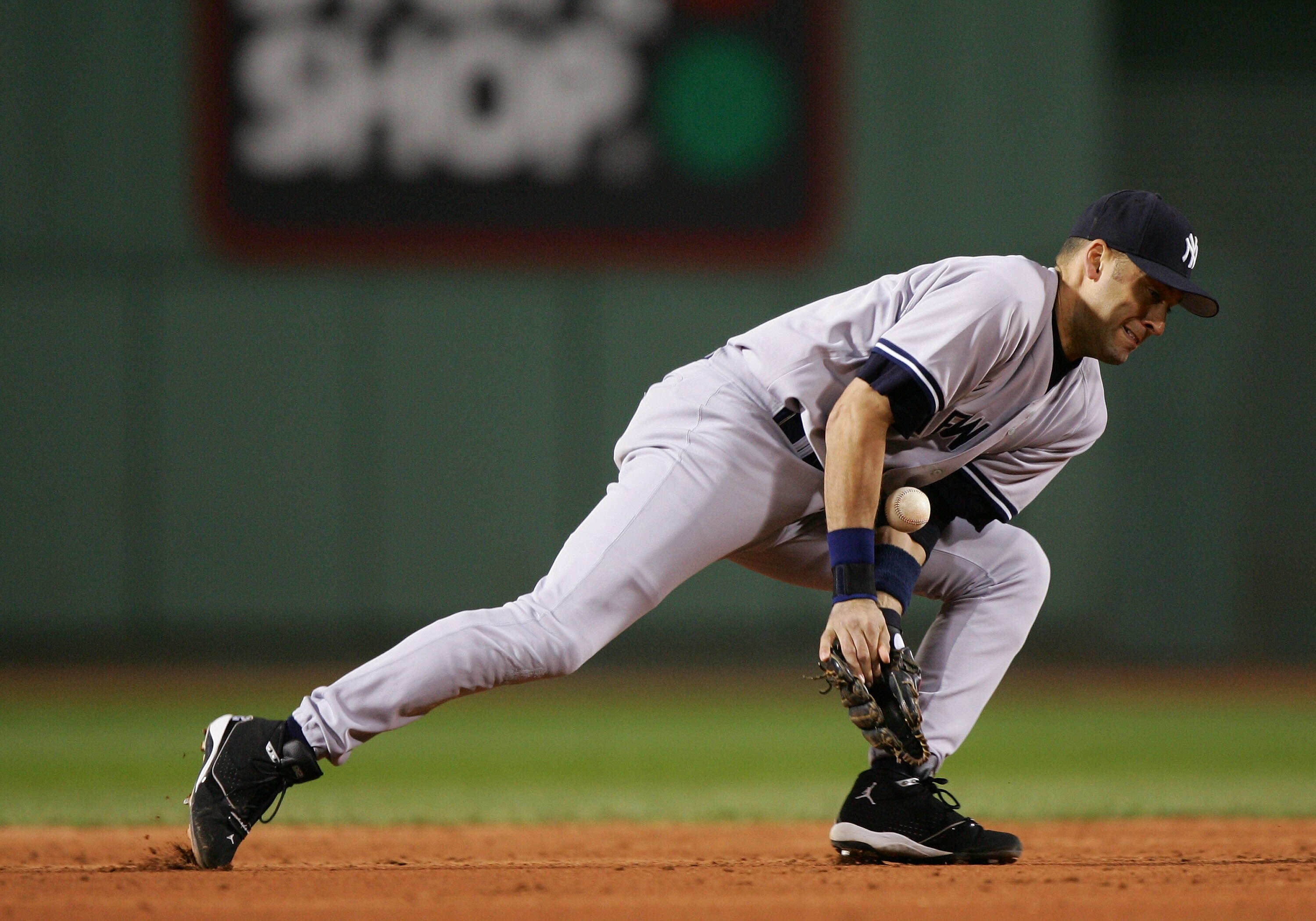 BOSTON - OCTOBER 18:  Derek Jeter #2 of the New York Yankees can not handle a groundball hit by Kevin Millar #15 of the Boston Red Sox in the third inning during game five of the American League Championship Series on October 18, 2004 at Fenway Park in Bo