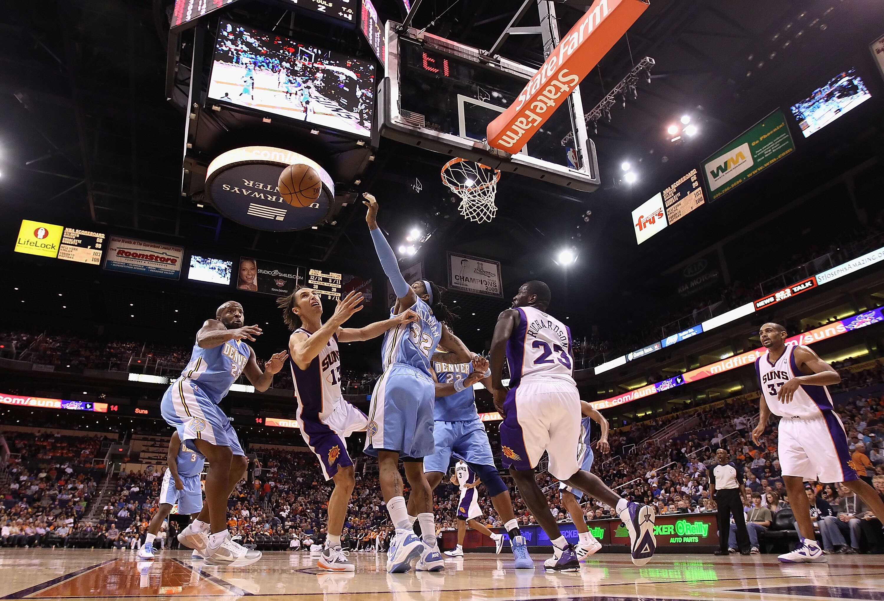 PHOENIX - OCTOBER 22:  Steve Nash #13 of the Phoenix Suns battles for a loose ball during the preseason NBA game against the Denver Nuggets at US Airways Center on October 22, 2010 in Phoenix, Arizona. NOTE TO USER: User expressly acknowledges and agrees
