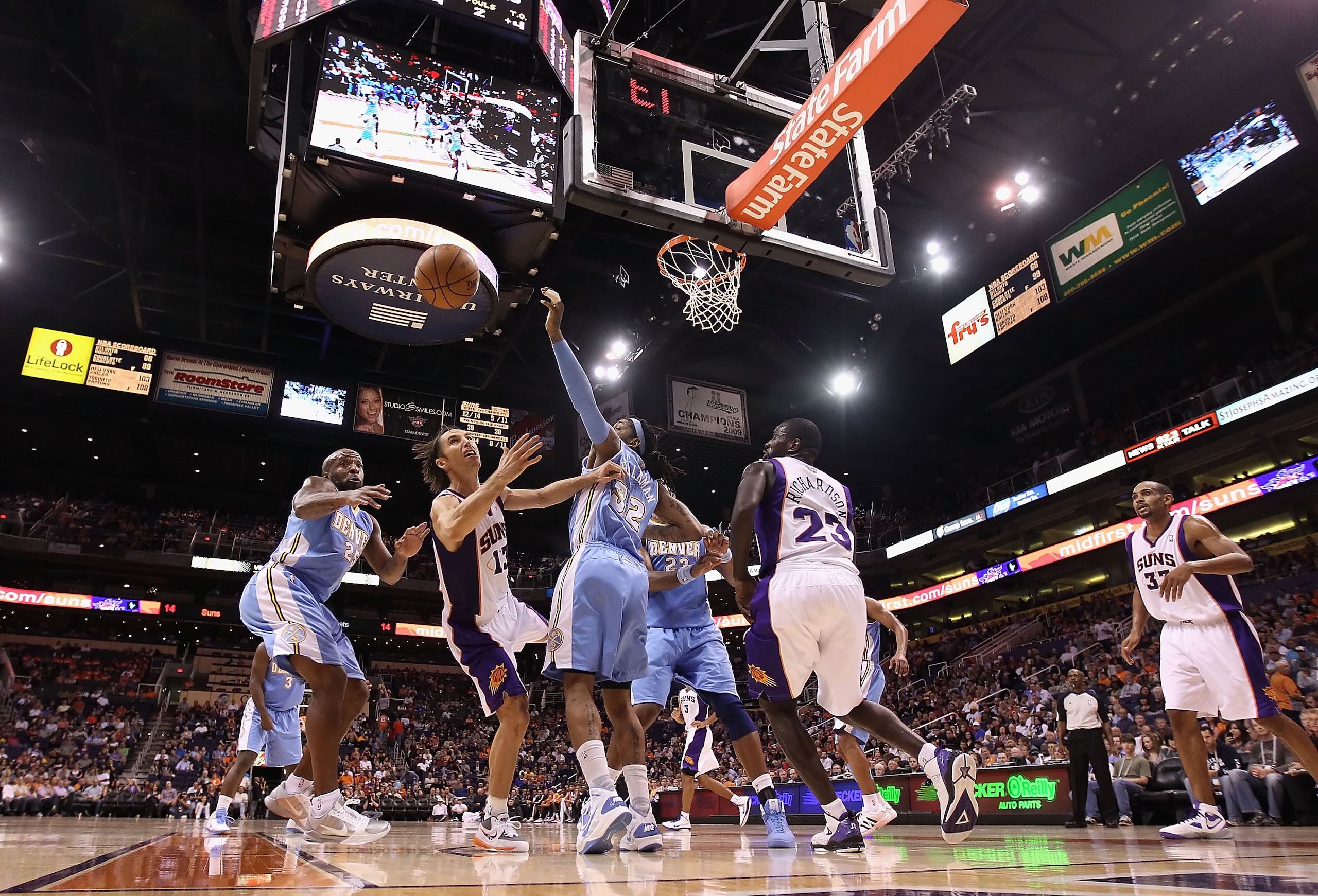 PHOENIX - OCTOBER 22:  Steve Nash #13 of the Phoenix Suns battles for a loose ball during the preseason NBA game against the Denver Nuggets at US Airways Center on October 22, 2010 in Phoenix, Arizona. NOTE TO USER: User expressly acknowledges and agrees