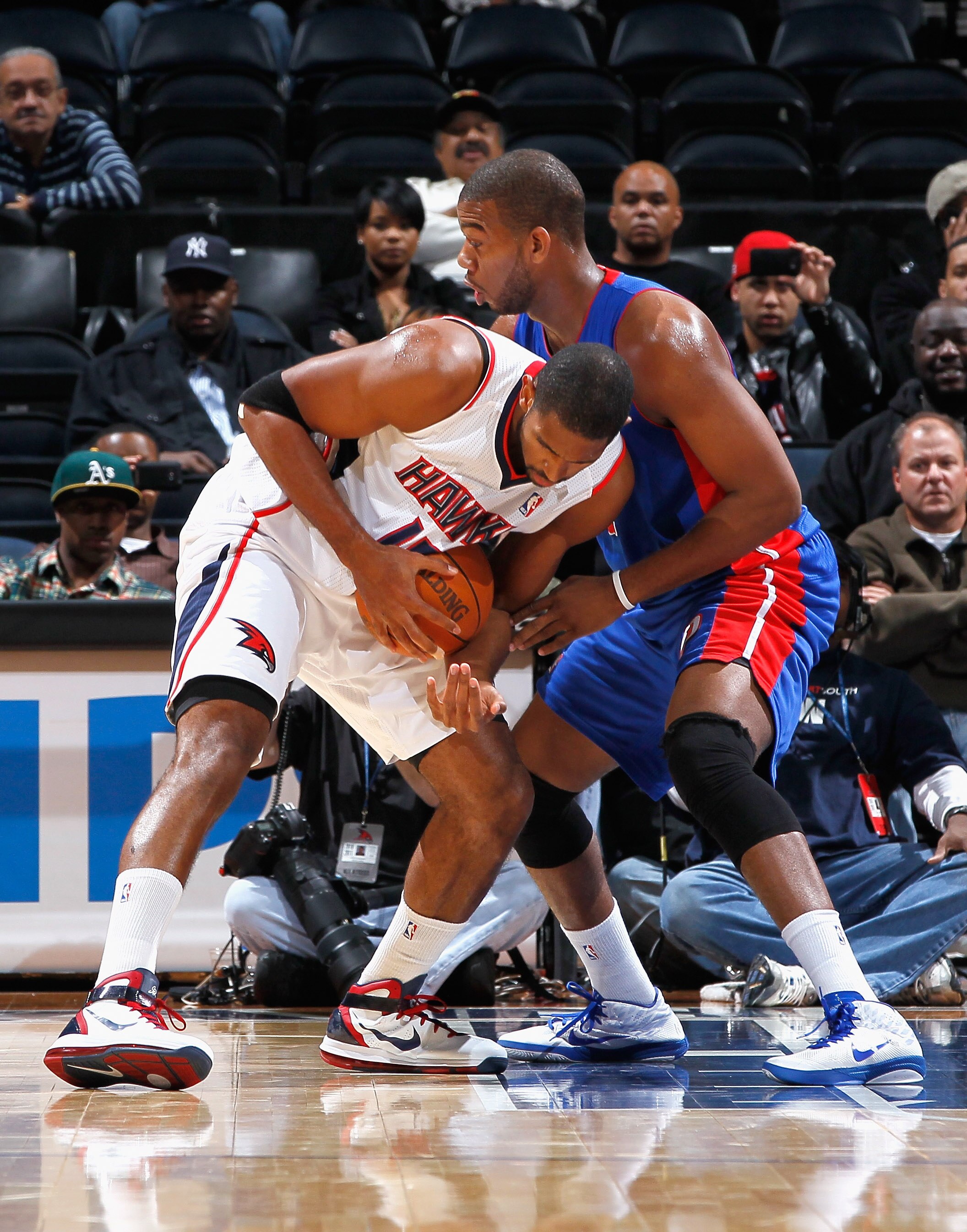 ATLANTA - NOVEMBER 03:  Al Horford #15 of the Atlanta Hawks looses grip on the ball as he drives into Greg Monroe #10 of the Detroit Pistons at Philips Arena on November 3, 2010 in Atlanta, Georgia.  NOTE TO USER: User expressly acknowledges and agrees th