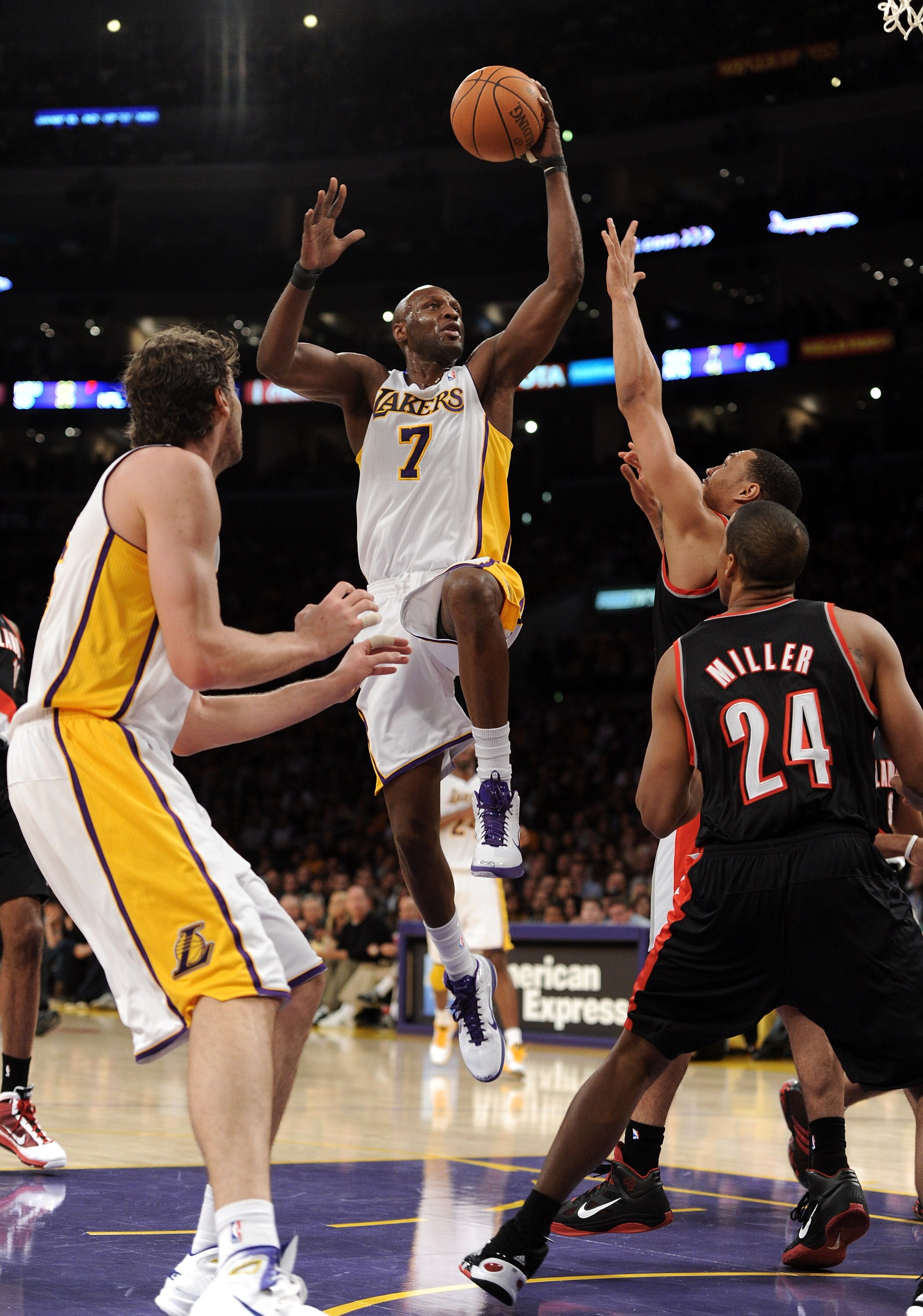 LOS ANGELES, CA - NOVEMBER 07:  Lamar Odum #7 of the Los Angeles Lakers goes in for a layup over Brandon Roy #7 and Andre Miller #24 of the Portland Trail Blazers during the first half at the Staples Center on November 7, 2010 in Los Angeles, California.