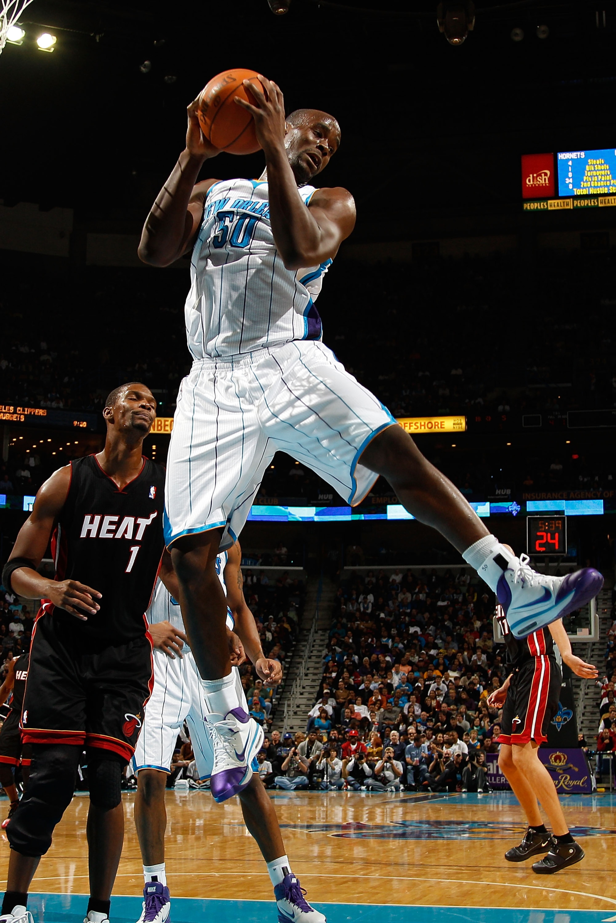 NEW ORLEANS - NOVEMBER 05:  Emeka Okafor #50 of the New Orleans Hornets grabs a rebound during the game against the Miami Heat at the New Orleans Arena on November 5, 2010 in New Orleans, Louisiana.  NOTE TO USER: User expressly acknowledges and agrees th