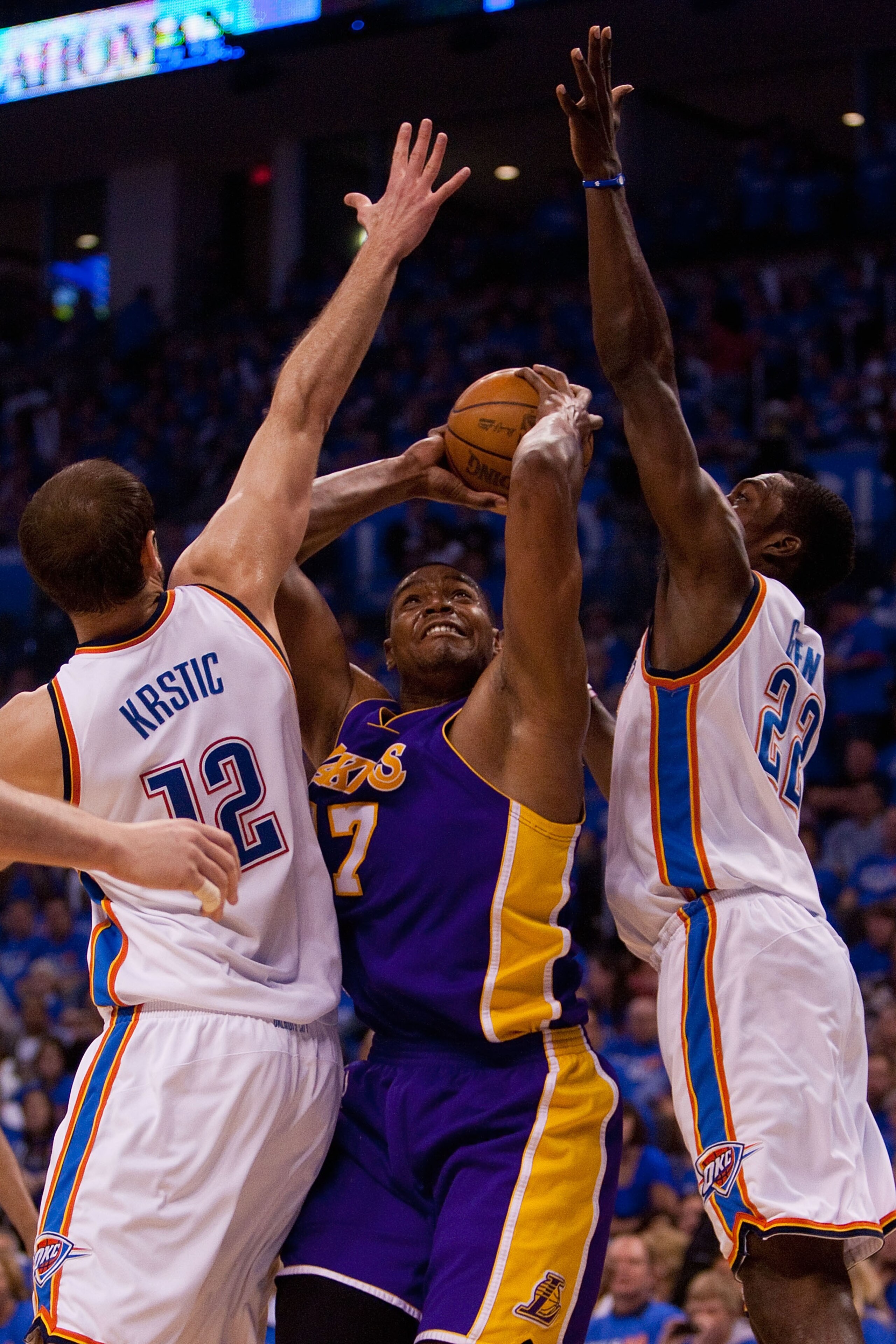 OKLAHOMA CITY - APRIL 30: Andrew Bynum #17 of the Los Angeles Lakers looks to shoot the ball against Jeff Green #22 and Nenad Krstic  #12 both of the Oklahoma City Thunder during Game Six of the Western Conference Quarterfinals of the 2010 NBA Playoffs on