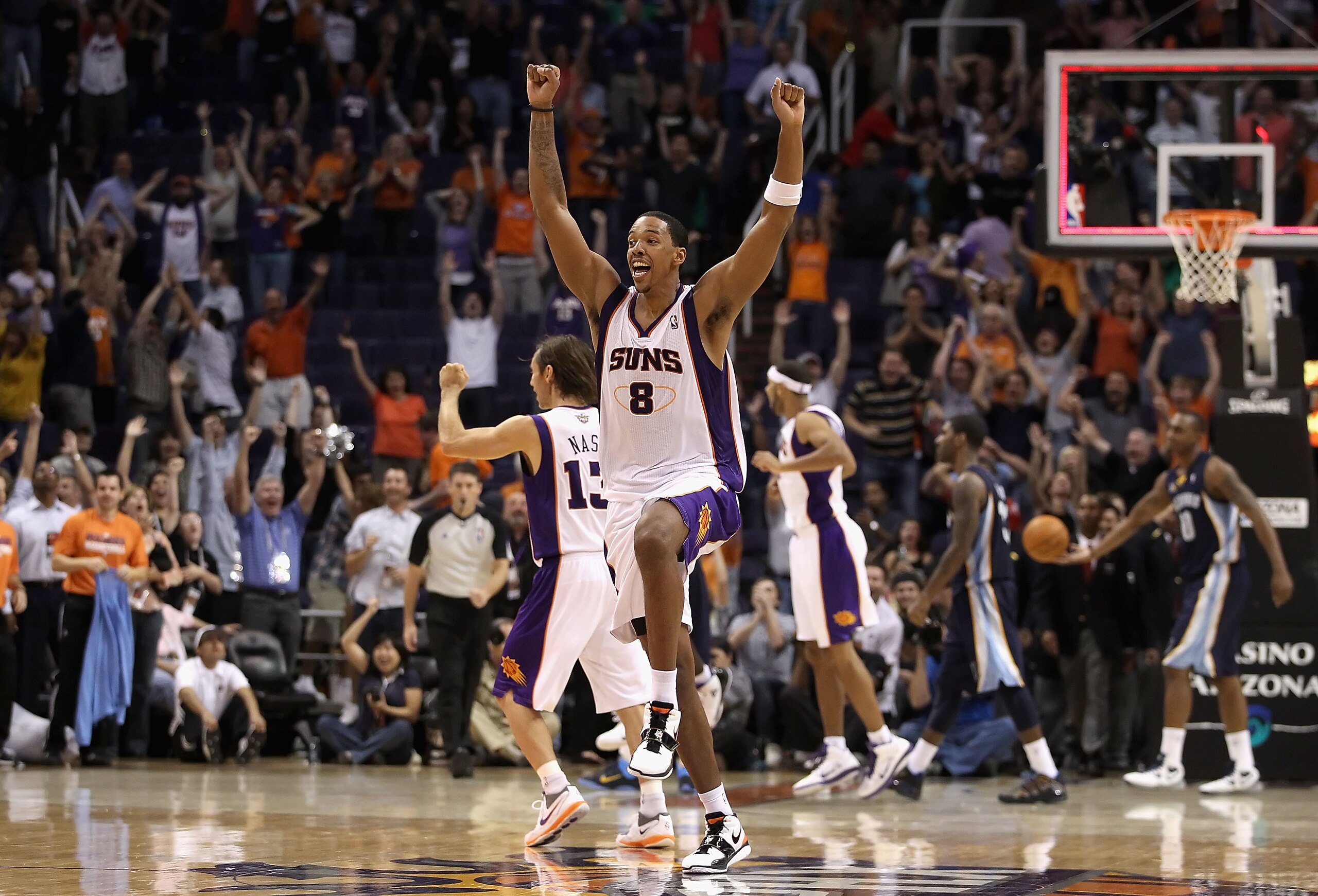 PHOENIX - NOVEMBER 05:  Channing Frye #8 of the Phoenix Suns celebrates after Jason Richardson tied the game in the final seconds to force overtime against the Memphis Grizzlies during the NBA game at US Airways Center on November 5, 2010 in Phoenix, Ariz