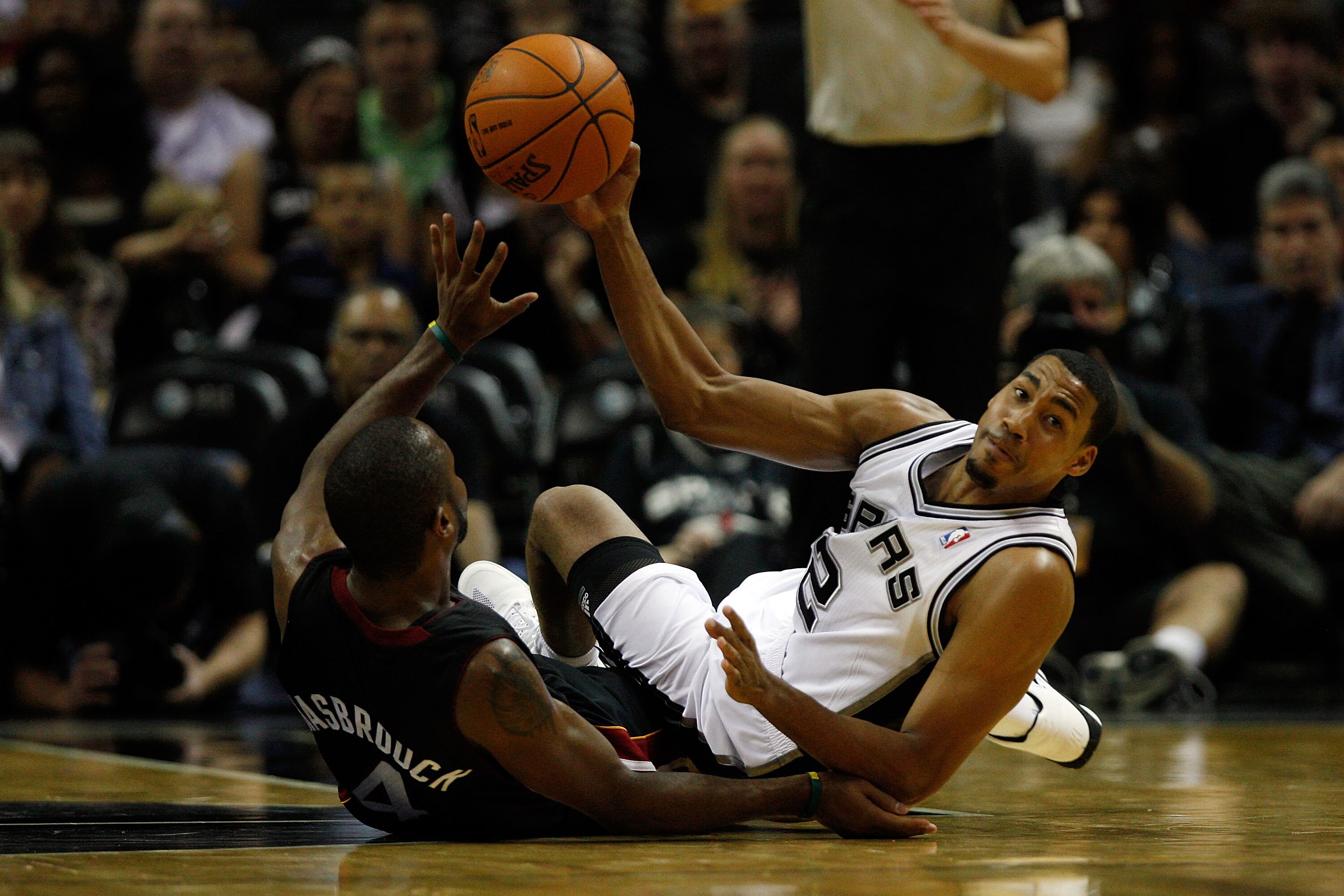 SAN ANTONIO - OCTOBER 09:  Kenny Hasbrouck #4 of the Miami Heat fights for a loose ball with Garrett Temple #2 of the San Antonio Spurs at the AT&T Center on October 9, 2010 in San Antonio, Texas.  NOTE TO USER: User expressly acknowledges and agrees that