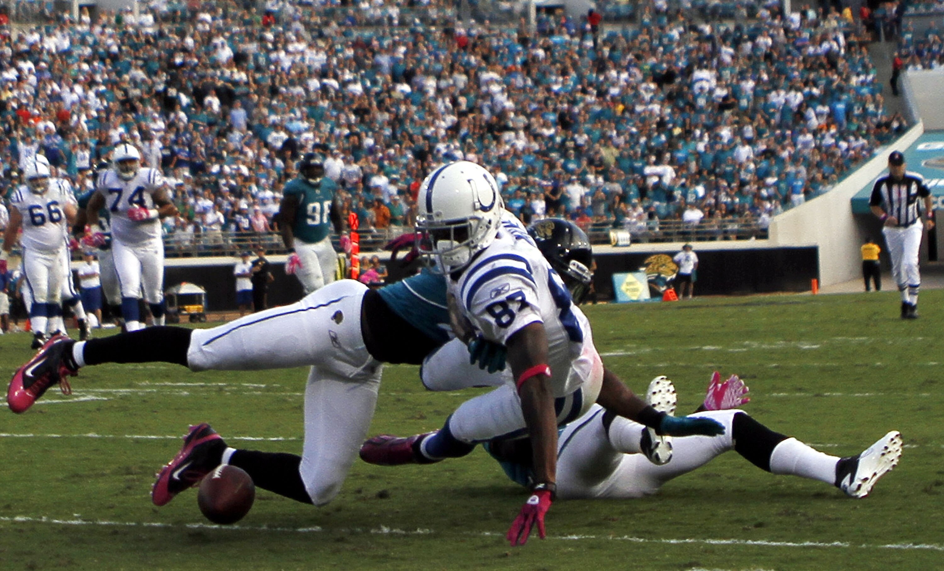 JACKSONVILLE, FL - OCTOBER 03:  Receiver Reggie Wayne #87 of the Indianapolis Colts fumbles against the Jacksonville Jaguars at EverBank Field on October 3, 2010 in Jacksonville, Florida. The Jaguars won 31-28.  (Photo by Marc Serota/Getty Images)
