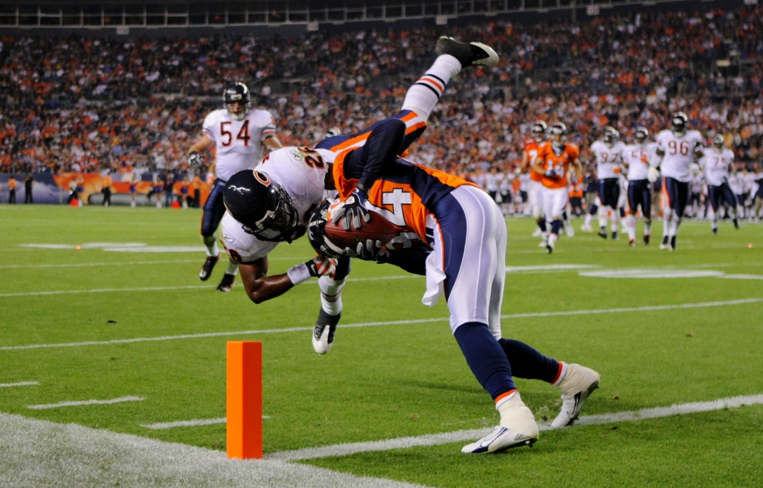 DENVER - AUGUST 30:  Wide receiver Brandon Lloyd #84 of the Denver Broncos catches a 16 yard pass against Trumaine McBride #26 of the Chicago Bears during the third quarter at INVESCO Field at Mile High on August 30, 2009 in Denver, Colorado.  (Photo by D