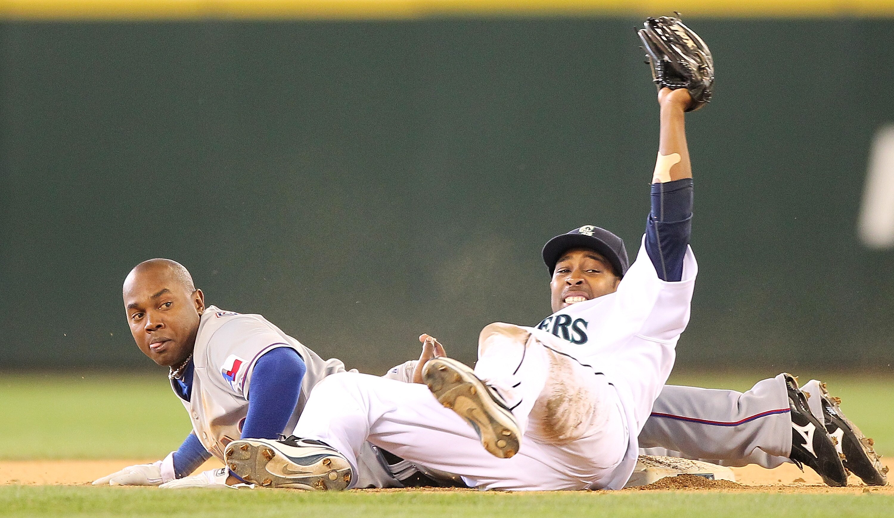 SEATTLE - SEPTEMBER 19:  Esteban German #6 of the Texas Rangers is tagged out on a steal attempt at second base by Chone Figgins #9 of the Seattle Mariners at Safeco Field on September 19, 2010 in Seattle, Washington. The Mariners defeated the Rangers 2-1